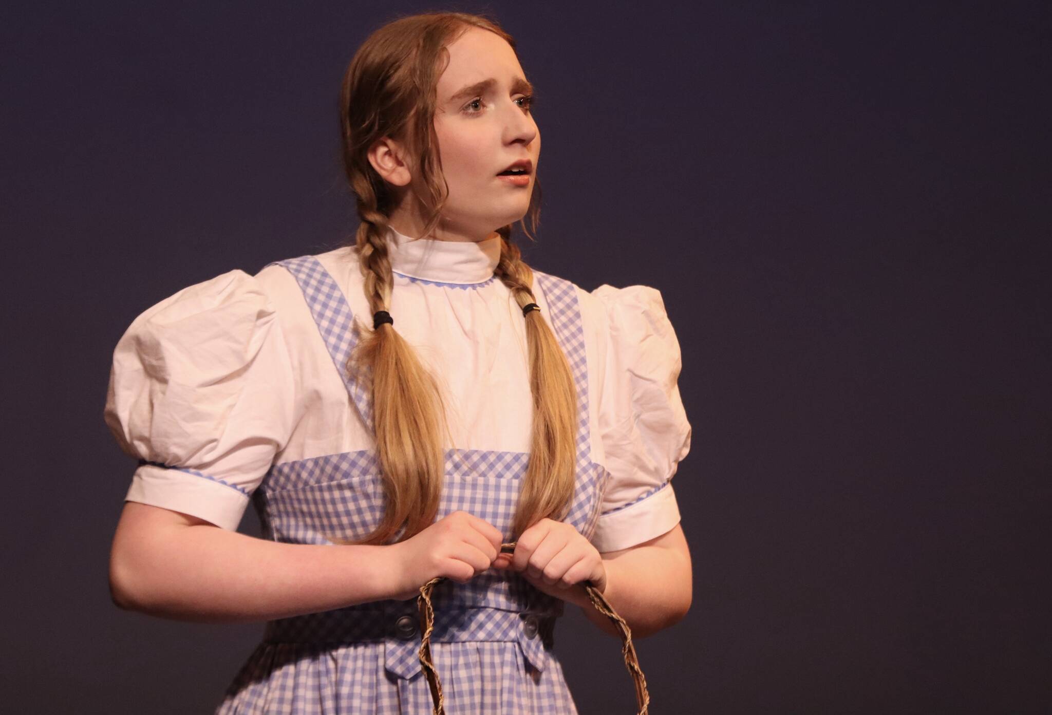 TMHS freshman Megan Peirce joins the case of “The Wizard of Oz” in the iconic role of Dorothy, now playing at the JDHS auditorium until Saturday, May 6. (Jonson Kuhn / Juneau Empire)