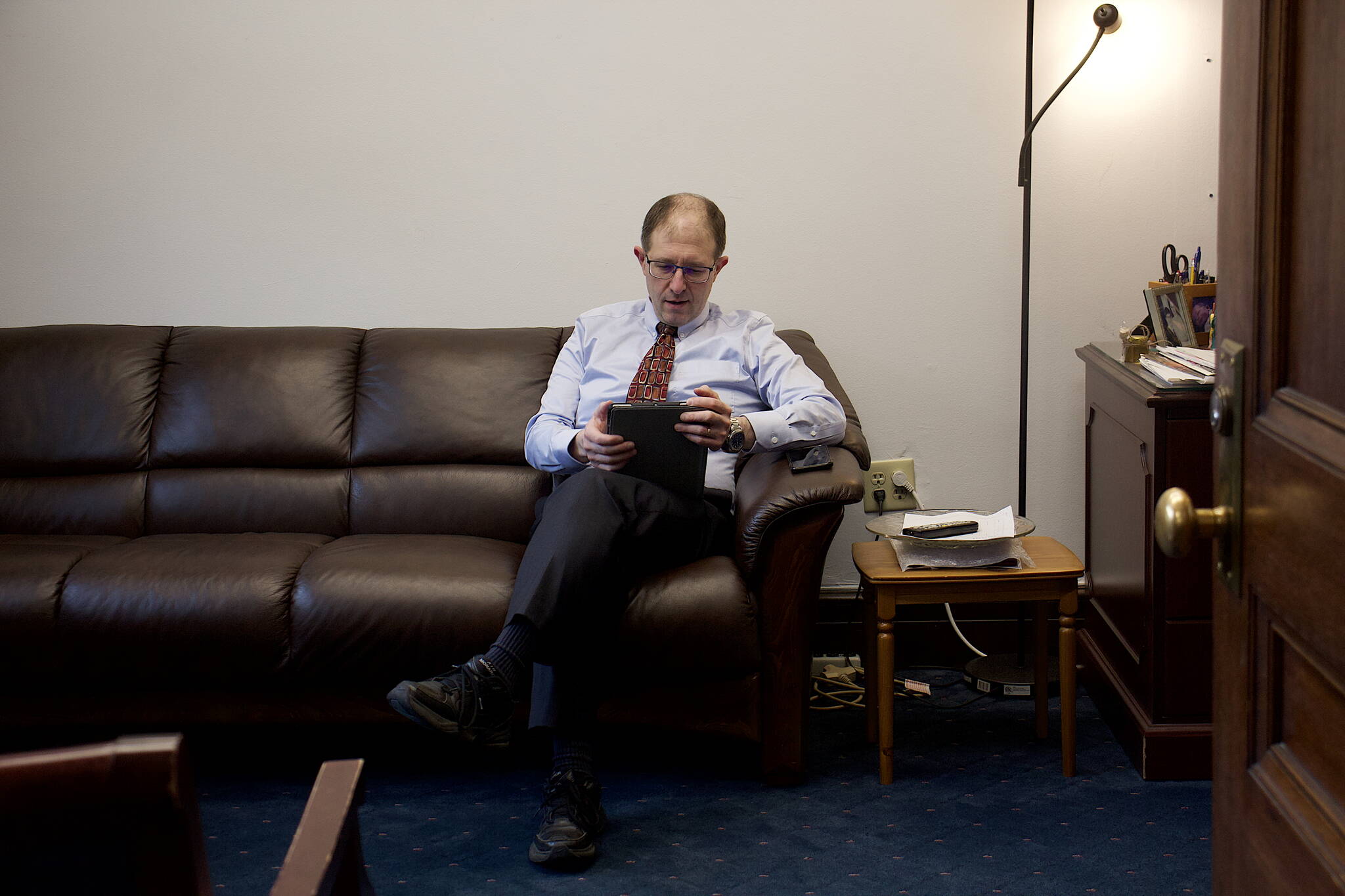 State Sen. Jesse Kiehl, D-Juneau, sits alone in his office Sunday morning as only a few people showed up at the Alaska State Capitol after both the House and Senate cancelled their scheduled floor sessions for the day. (Mark Sabbatini / Juneau Empire)