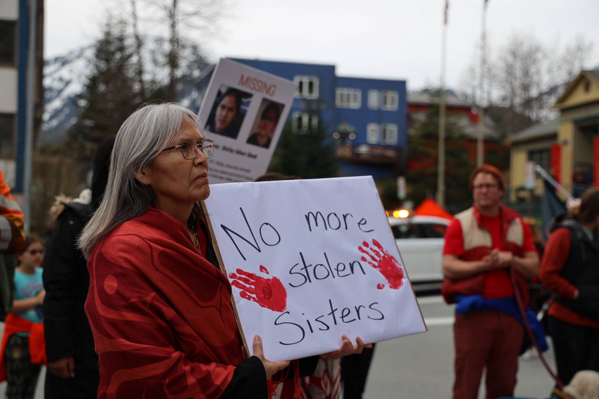 Eunice James holds a sign while listening to speakers at the Alaska State Capitol Friday evening for a rally and march to recognize Missing and Murdered Indigenous Peoples Awareness Day held each year on May 5. (Clarise Larson / Juneau Empire)