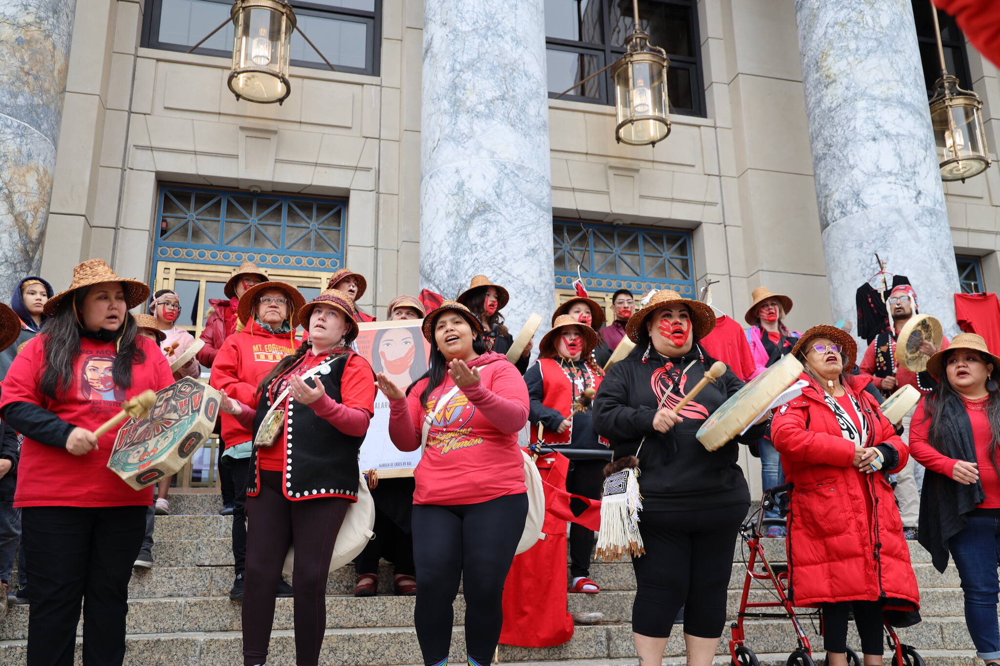 Bamby Kinville-James (left center) and Jeni Brown (right center) lead a song during the rally held at the steps of the Alaska State Capitol Friday evening to recognize Missing and Murdered Indigenous Peoples Awareness Day held each year on May 5. (Clarise Larson / Juneau Empire)