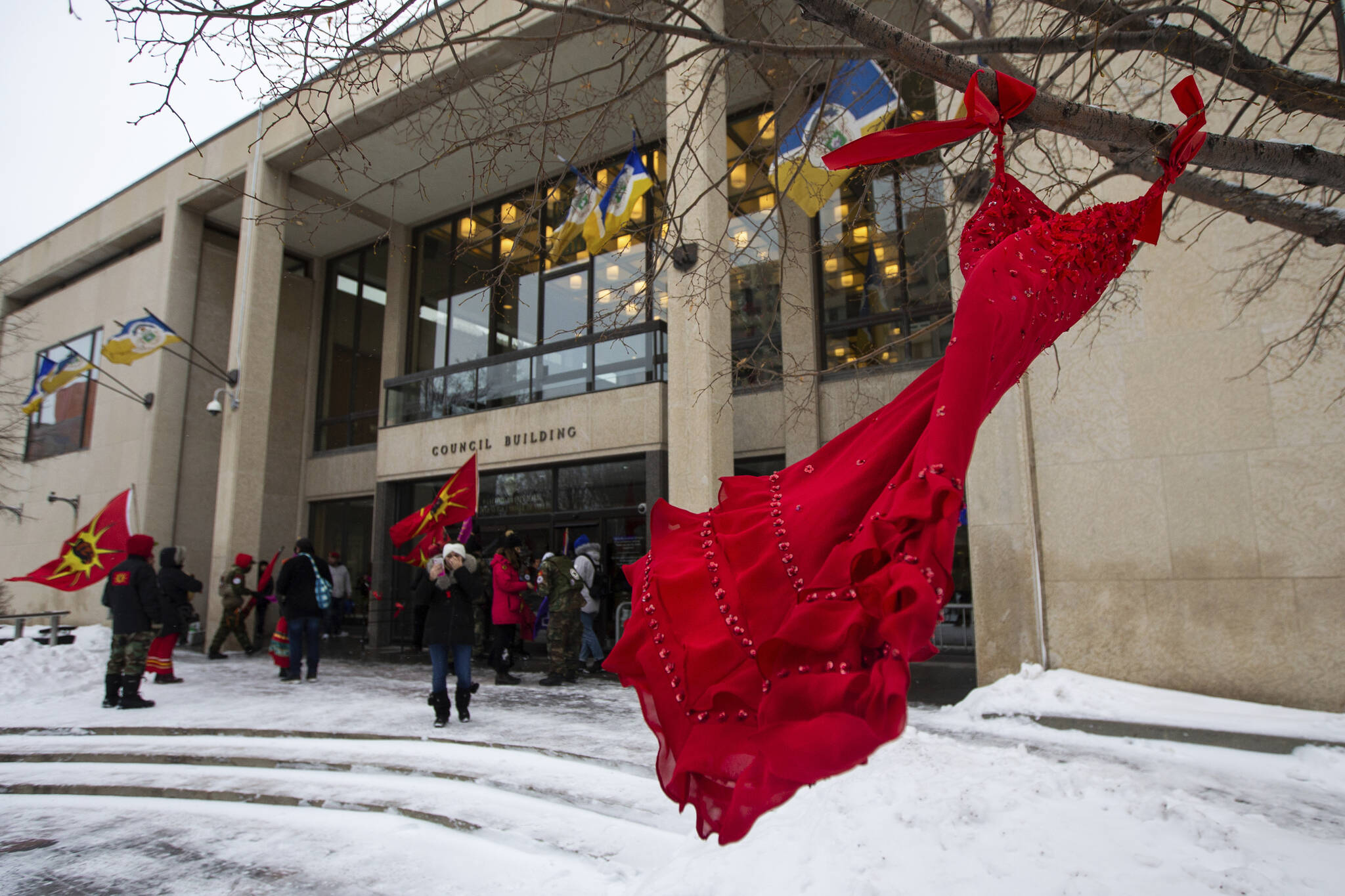 A red dress hangs on a tree in the courtyard at Winnipeg City Hall during a rally, Thursday, Dec. 15, 2022, in Winnipeg, Manitoba, to call on the city to cease dumping operations at Brady landfill and conduct a search for the remains of missing and murdered indigenous women believed to be buried there. Friday, May 5, 2023, marks Missing and Murdered Indigenous Peoples Awareness Day, a solemn day meant to draw more attention to the disproportionate number of Indigenous people who have vanished or have faced violence. (Daniel Crump / The Canadian Press)