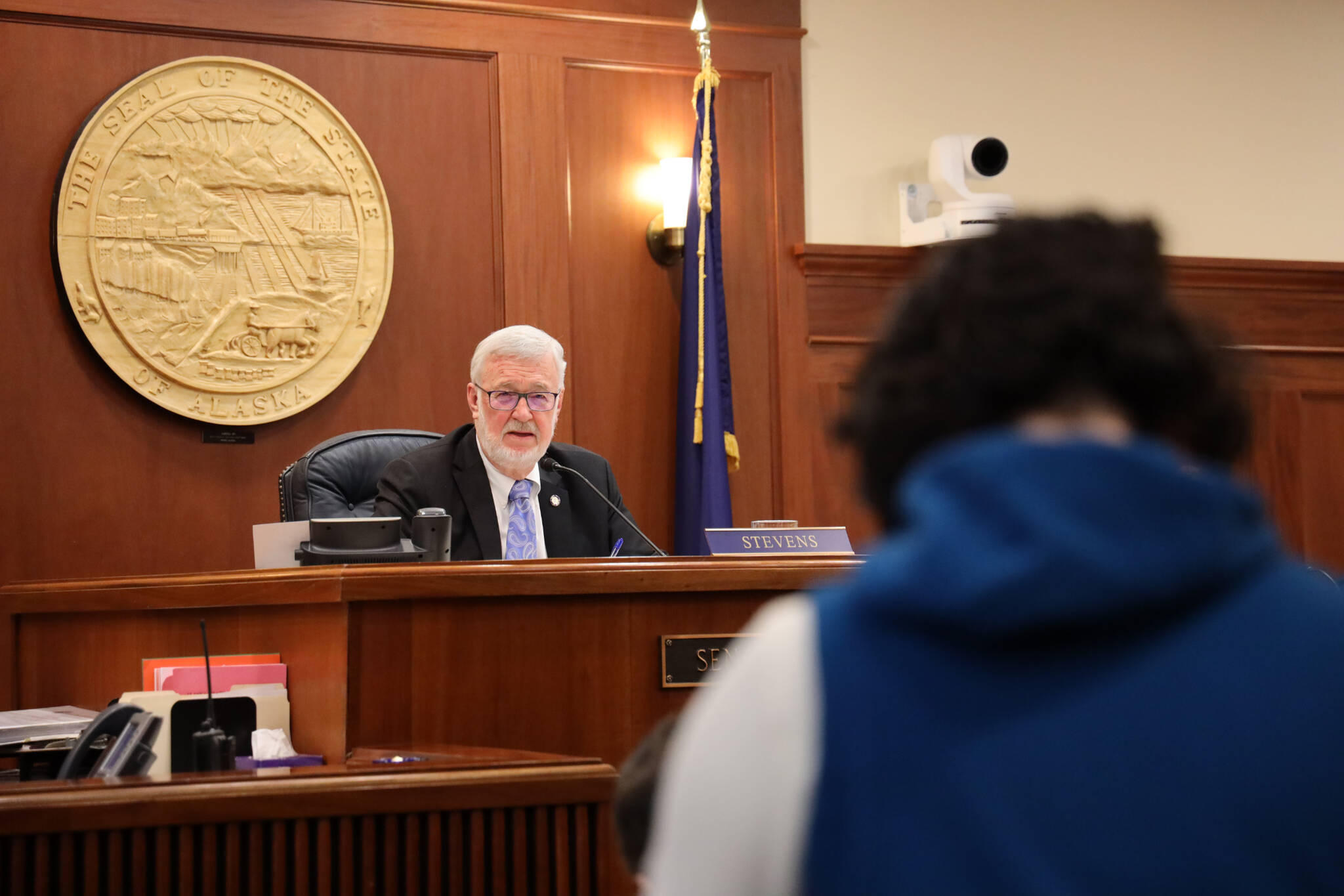 Senate President Gary Stevens, a Kodiak Republican, listens to Sen. Löki Tobin, an Anchorage Democrat, as she speaks in support of a bill Stevens sponsored that would require Alaska high school students to complete a civics education course or receive a passing score on a civics assessment exam in order to graduate. (Clarise Larson / Juneau Empire)
