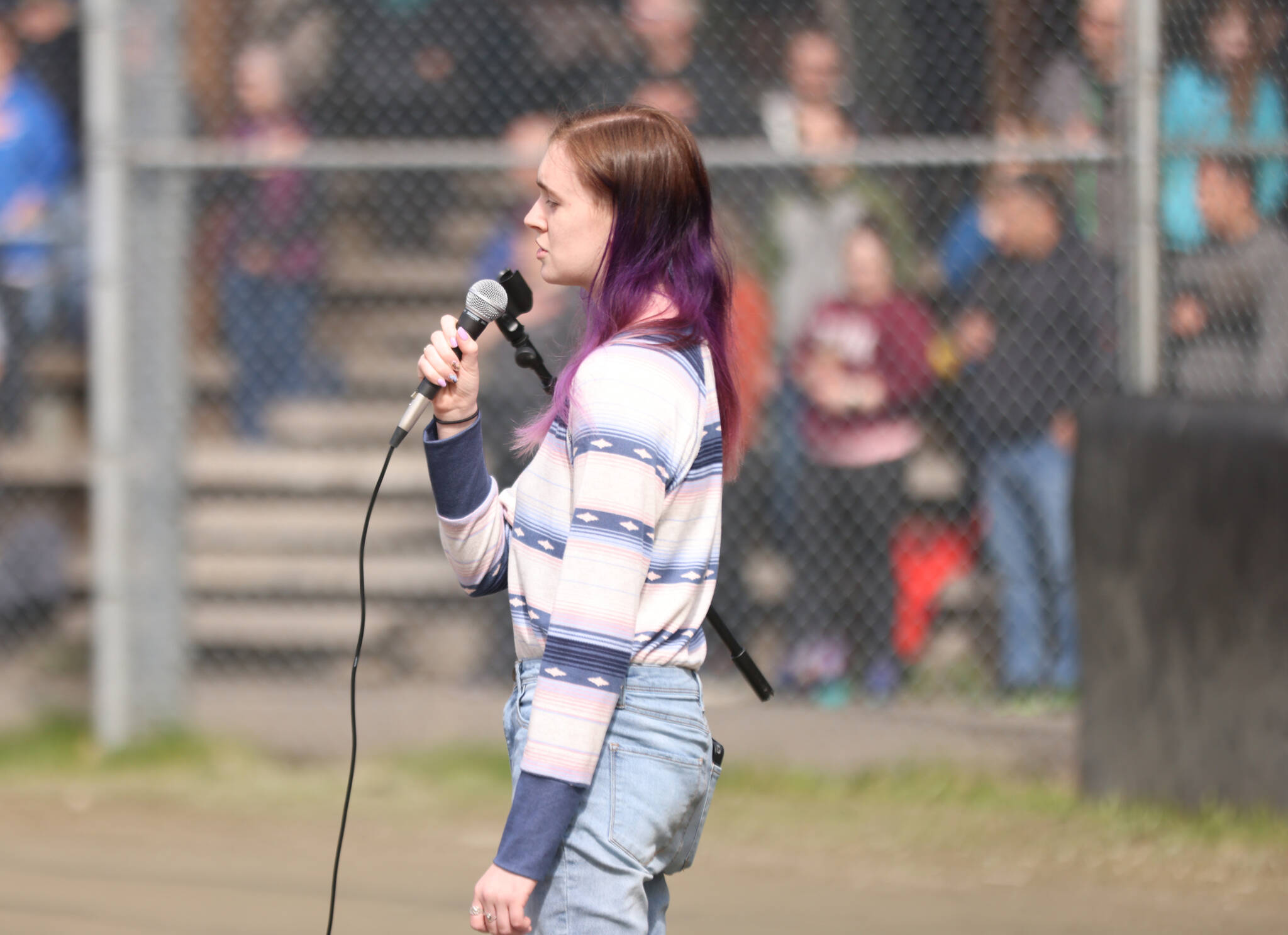 Kelsi Sell, a senior at Thunder Mountain High School, sings the national anthem Saturday at Adair-Kennedy Memorial Park during Gastineau Channel Little League’s opening day ceremonies. (Ben Hohenstatt / Juneau Empire)