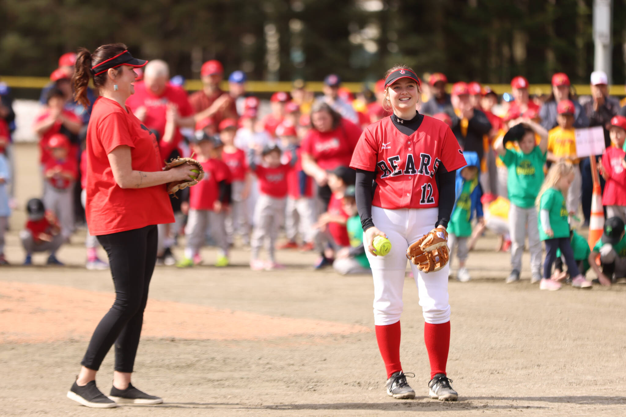  Ben Hohenstatt / Juneau Empire
Mandy Massey smiles at her daughter, Gloria Bixby, before the two threw simultaneous ceremonial first pitches Saturday at Adair-Kennedy Memorial Park. Massey and Bixby have a direct line to the inception of Gastineau Channel Little League softball as Massey’s father, David, was integral in the formation of the program.
