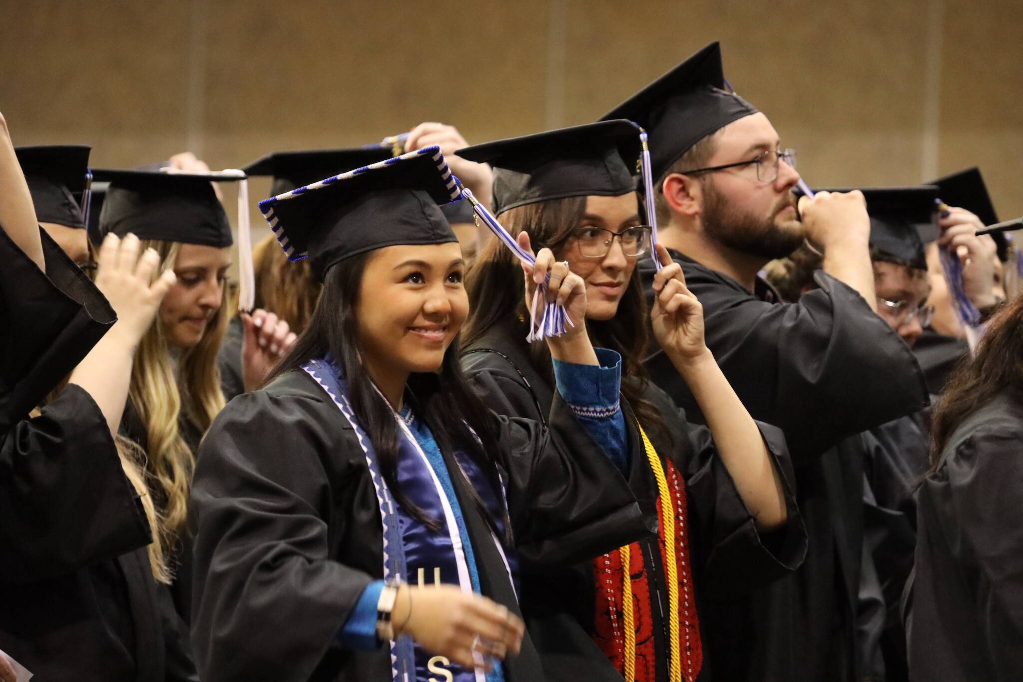 Elizabeth Autumn Dawn Ferguson switches her tassel alongside other students to signify their status as graduates at the commencement ceremony for University of Alaska Southeast Sunday afternoon. (Clarise Larson / Juneau Empire)
