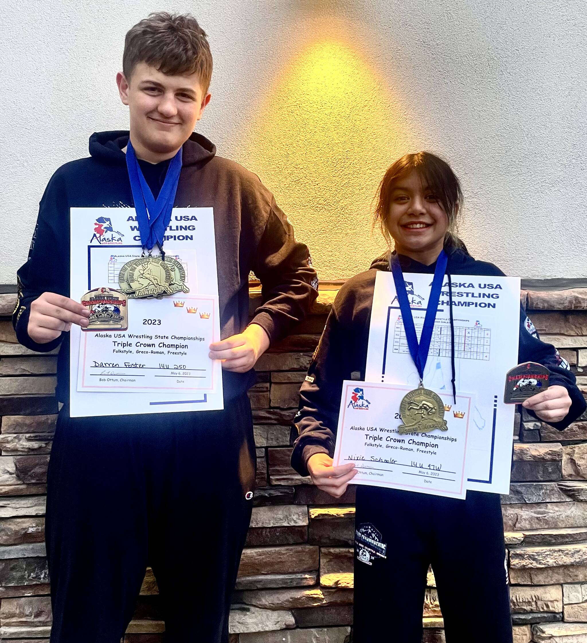 Darren Foster and Nixie Schooler with some of their gold medals and their prestigious “Triple Crown” belt buckles at the USA Wrestling Alaska State Championships at the Menard Center in Wasilla from May 3-7. (Courtesy Photo / Jason Hass)