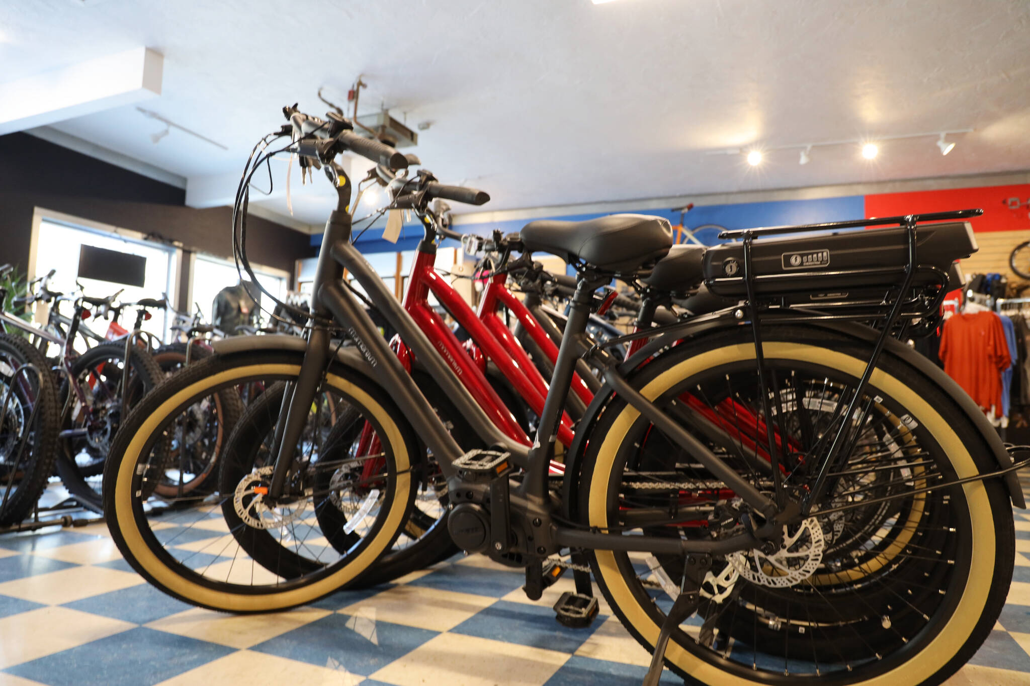 A line of electric-assisted bicycle sit on display at Juneau Bike Doctor in February. On Monday the Senate passed a bill that would to regulate e-bikes under the same regulations as normal bicycles. (Clarise Larson / Juneau Empire File)