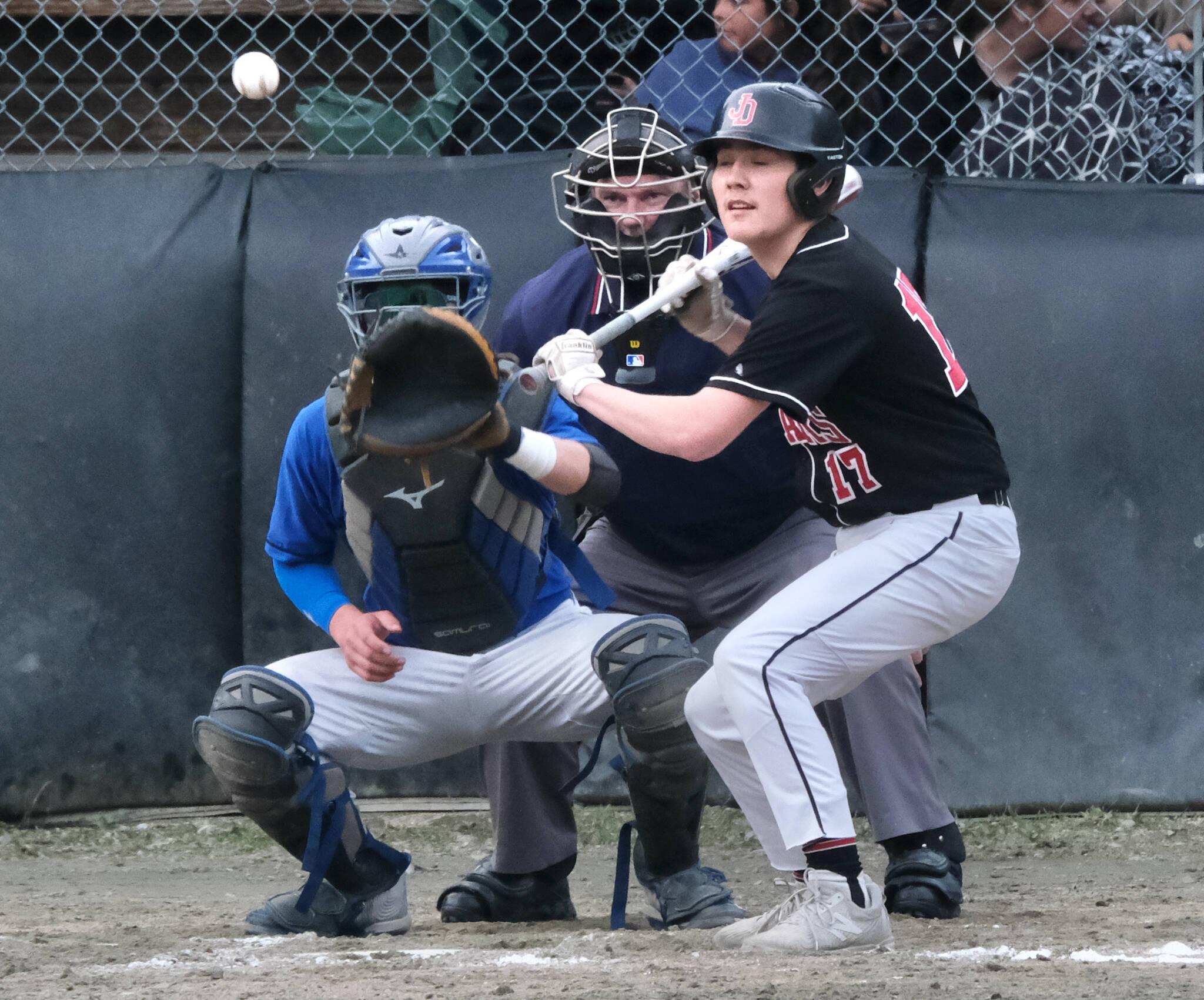 TMHS catcher Rory Hayes and umpire Tom Mayer wait for a pitch as JDHS batter Christian Nelson pulls back from a bunt during the Falcons 9-6 win over the Crimson Bears on Tuesday at Adair Kennedy Field. (Klas Stolpe / Juneau Empire)