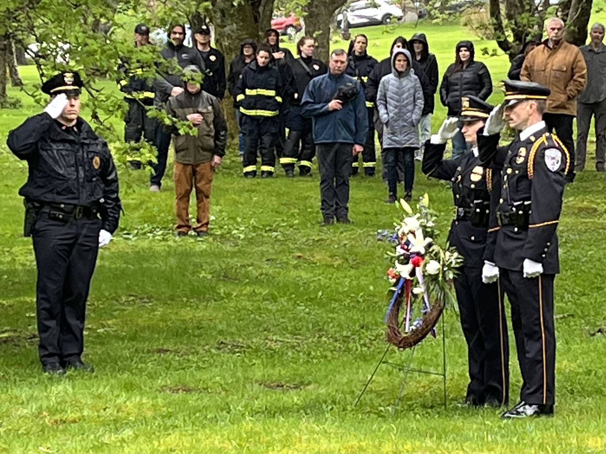 Lt. Krag Campbell salutes members of the Inter-Agency Honor Guard as wreaths were laid at the graves of Chief of Detectives Donald Thomas Dull and Officer Richard J. Adair on Friday during the Alaska Peace Officers Association’s annual memorial service at Evergreen Cemetery. (Jonson Kuhn / Juneau Empire)