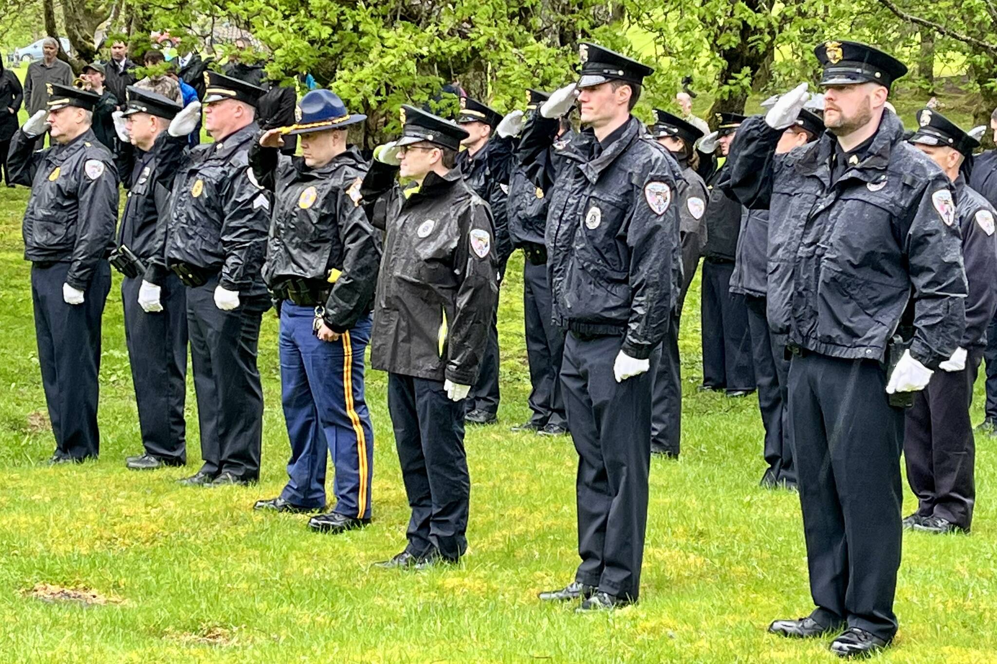 Members of the Juneau Police Department stand at attention to honor fallen officers on Friday during the Alaska Peace Officers Association’s annual memorial service at Evergreen Cemetery. (Jonson Kuhn / Juneau Empire)