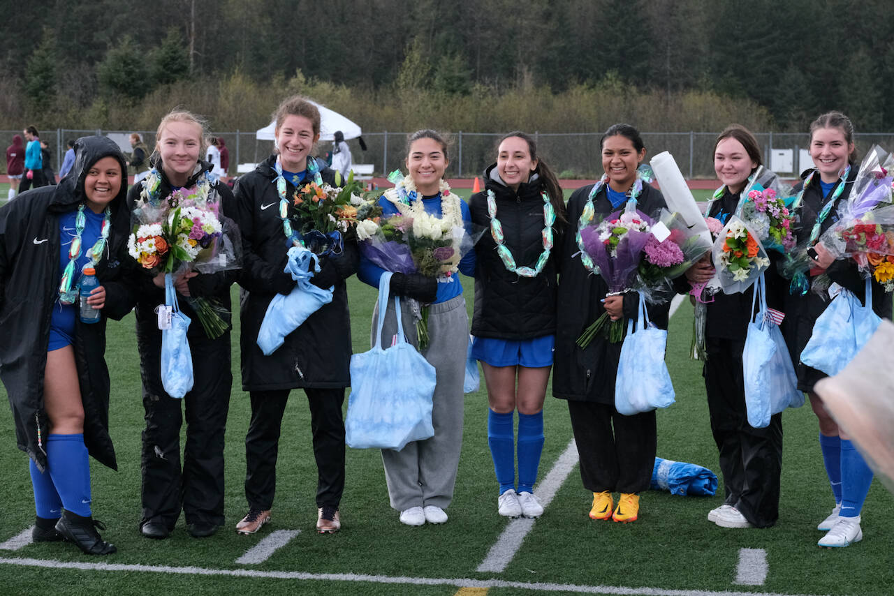 TMHS senior soccer players pose before their match on Friday. From left: Kylie Morris, Kaelin Tibbles, Mackenzie Olver, Brooke McAndrews, Ana Scopel, Mercedes Cordero, Lillian Palmer-Stears and Samantha Mead. (Klas Stolpe / Juneau Empire)