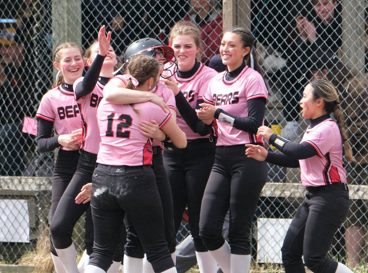 Juneau-Douglas High School: Yadaa.at Kalé senior Anna Dale is hugged by classmate Gloria Bixby (12) as players celebrate her game winning hit during Saturday’s extra inning win over Ketchikan at Melvin Park. (Klas Stolpe / Juneau empire).