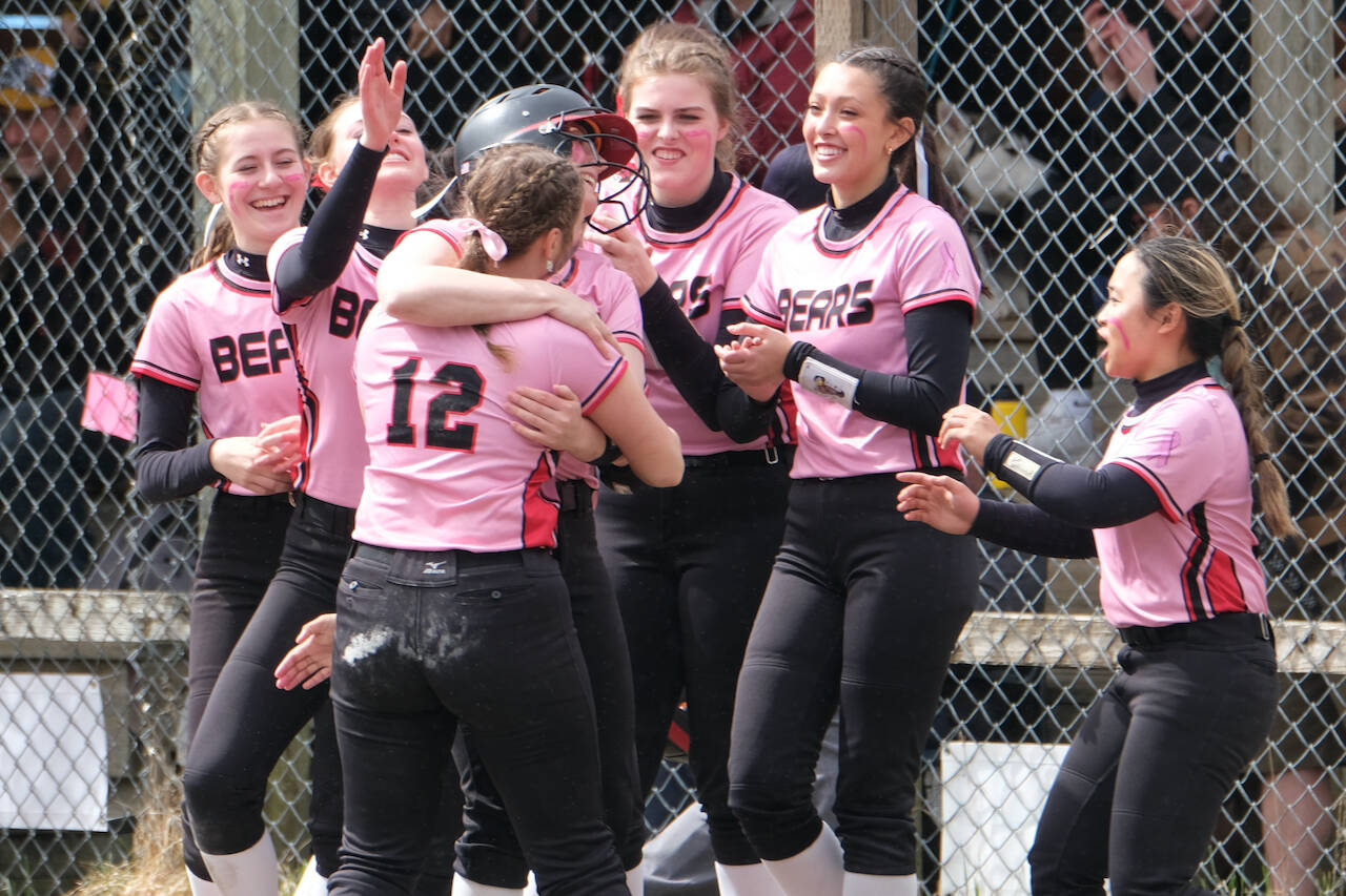 Juneau-Douglas High School: Yadaa.at Kalé senior Anna Dale is hugged by classmate Gloria Bixby (12) as players celebrate her game winning hit during Saturday's extra inning win over Ketchikan at Melvin Park. (Klas Stolpe / Juneau empire).