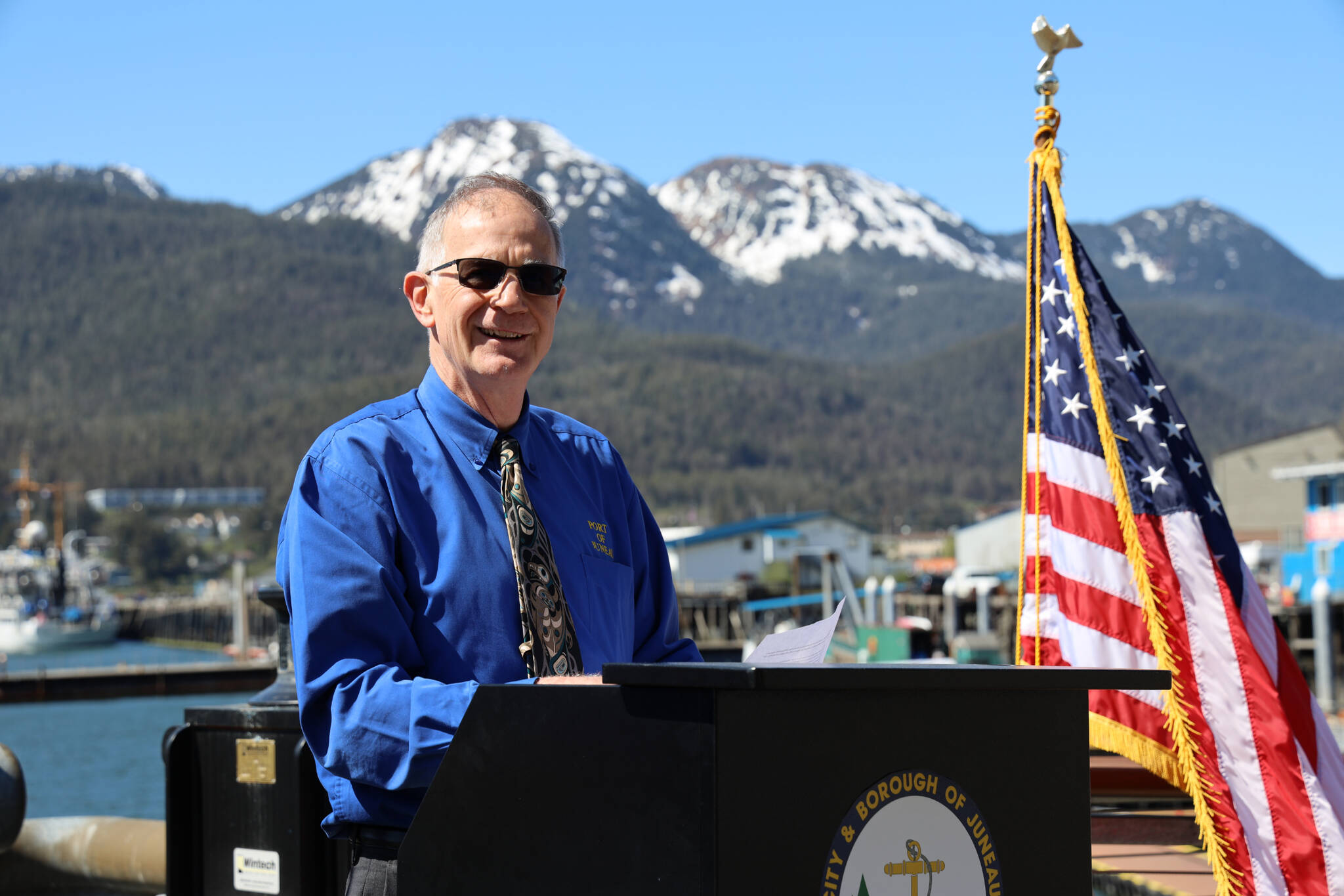 City and Borough of Juneau Port Director Carl Uchytil smiles Monday afternoon at the Seawalk as he gives a speech celebrating the city’s completion of the Docks and Harbors Marine Deckover Project. (Clarise Larson / Juneau Empire)