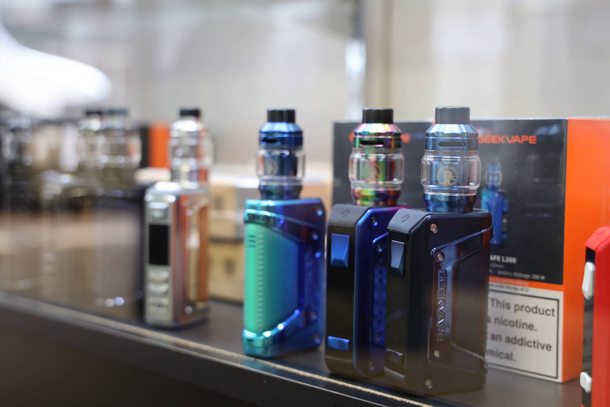 An array of vapes line the shelf of a display case at Alaska Pipeline vape store downtown. The Alaska Senate passed a bill that would impose a 25% statewide tax on retail e-cigarette products in Alaska Tuesday morning. It now heads to the House. (Clarise Larson / Juneau Empire)
