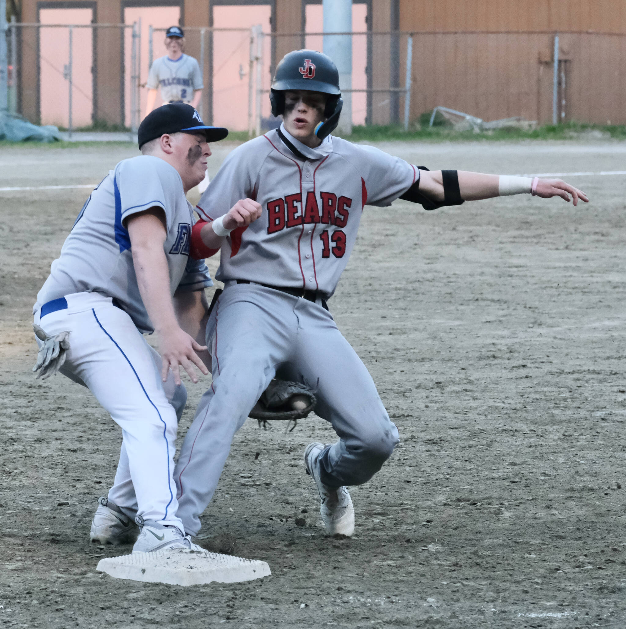 Thunder Mountain senior first baseman TJ Womack tags out Juneau-Douglas High School: Yadaa.at Kalé senior base runner Kaleb Campbell (13) on a pickoff move from Falcons’ pitcher Anthony Anderson in the top of the fourth inning Tuesday at Adair-Kennedy Field. (Klas Stolpe / Juneau Empire)