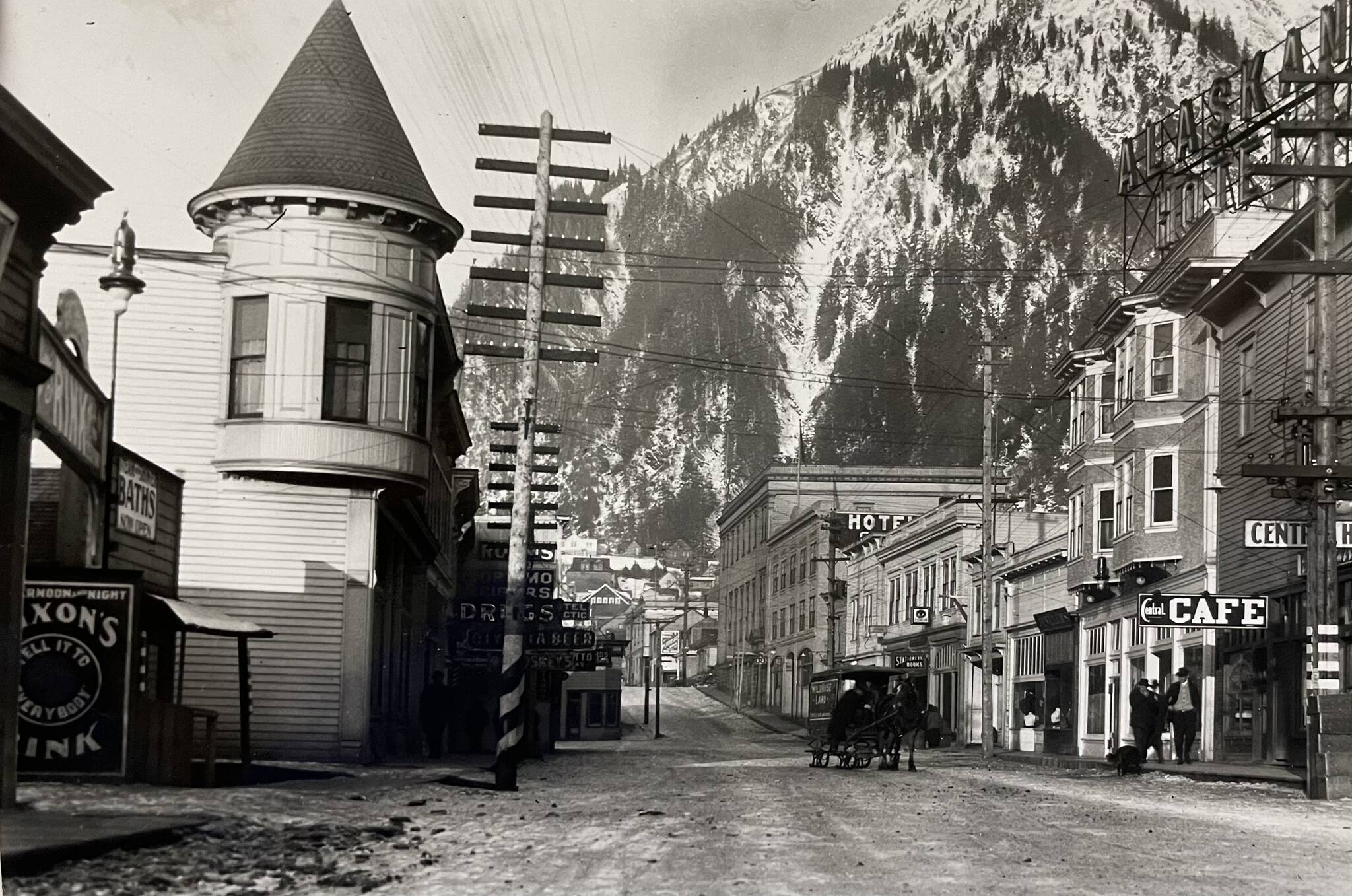 By 1914 when this photo was taken, Juneau had developed into an established city. The Victorian era turreted Alaska Steam Laundry (built 1901) is seen on the left, while other buildings such as the Alaskan Hotel and Central Rooming House are on the right. The rooming house was reconstructed in the 1980s. It is now the Senate Mall. (Alaska State Library-P31-021).