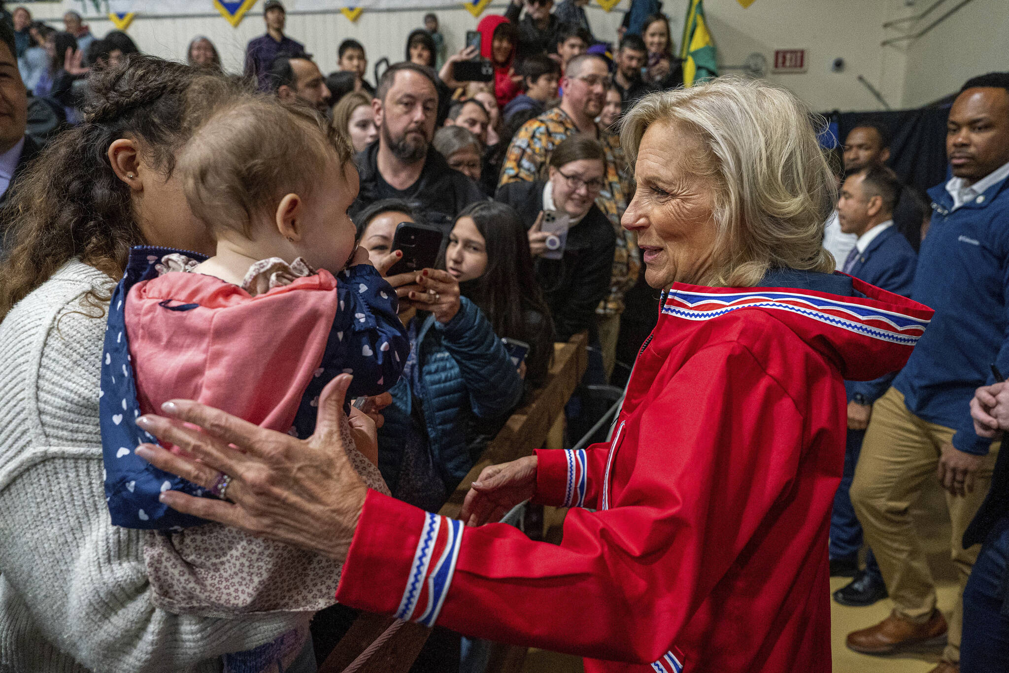 First lady Jill Biden greets Bethel residents Coralie Williams, 7 months, and her mom Courtney Williams, after an event at Bethel Regional High School in Bethel, Alaska on Wednesday, May 17, 2023. Biden and Interior Secretary Deb Haaland traveled to Bethel to highlight the Biden-Harris administration’s investments to expand broadband internet connectivity in Native American communities, including Alaska’s Yukon-Kuskokwim Delta. (Loren Holmes/Anchorage Daily News via AP)