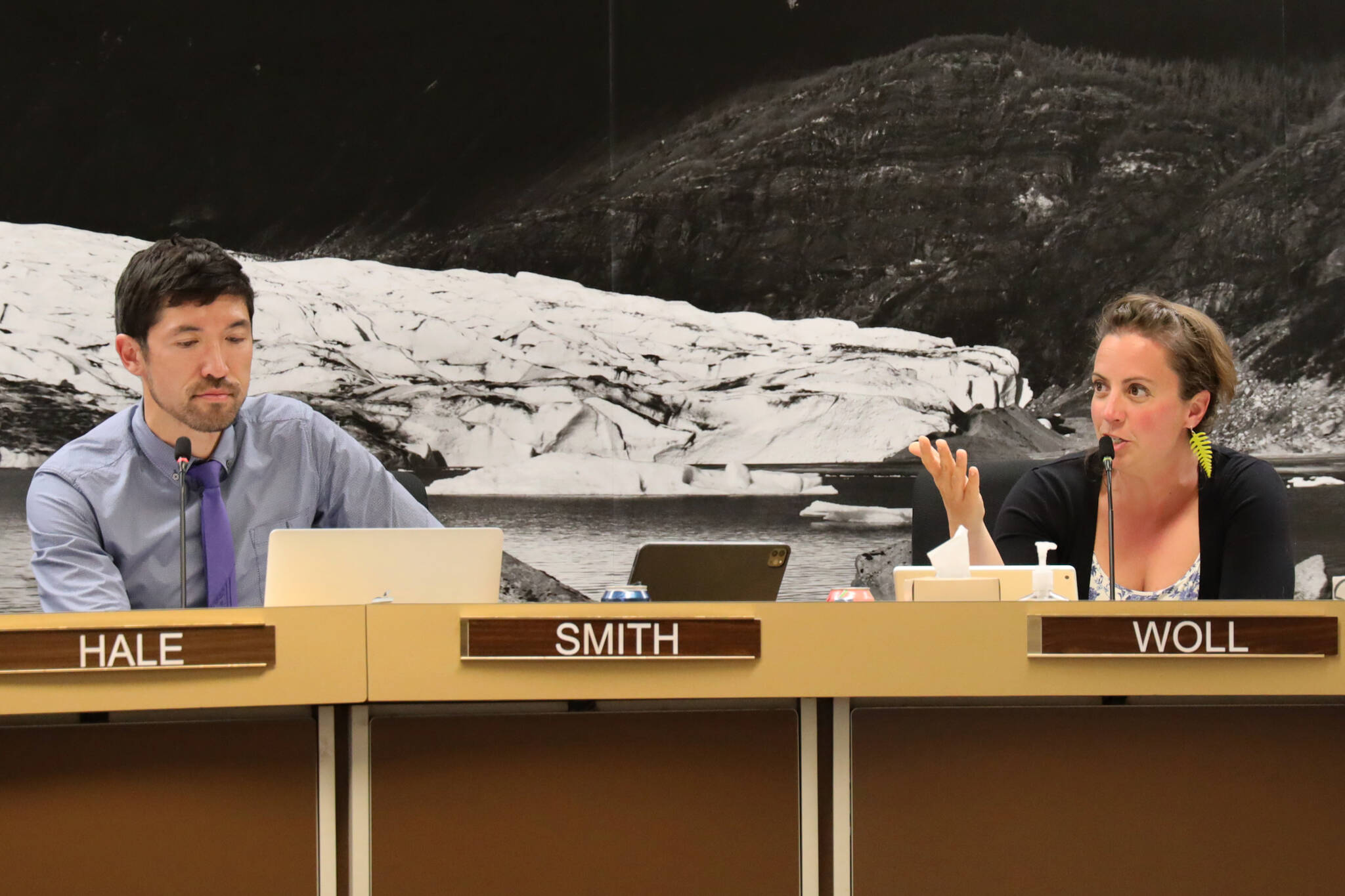 City and Borough of Juneau Assembly member Greg Smith and Christine Woll discuss the mill rate during Wednesday night’s Finance Committee meeting. Member voted to decrease the mill rate to 10.16. (Clarise Larson / Juneau Empire)