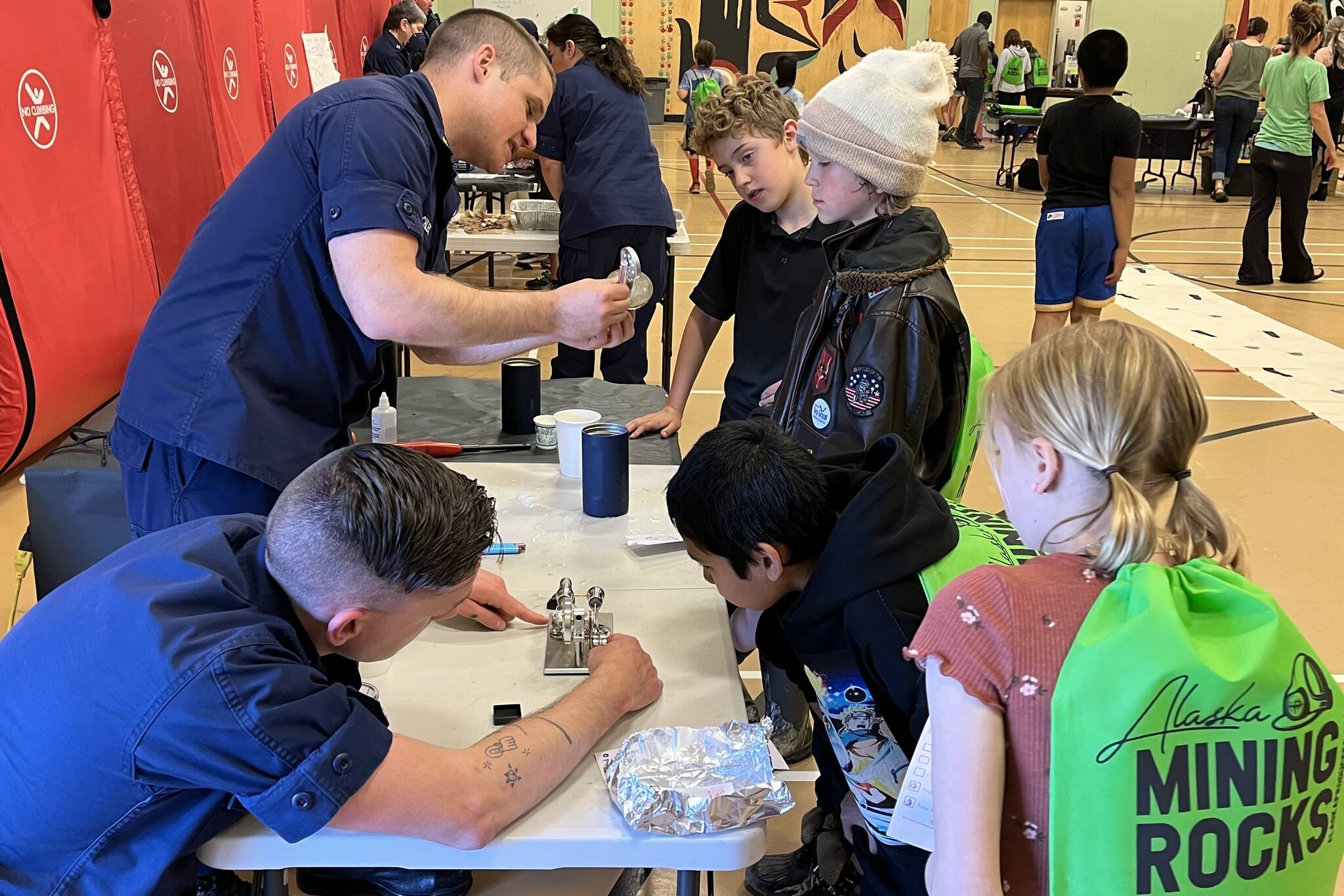 The Science of the Stirling Engine with Lt. Evan Sutton and LCDR Christopher Schleck of the U.S. Juneau Coast Guard was one of several stations featured for Sayéik: Gastineau Community School’s STEAM event on Thursday. (Jonson Kuhn / Juneau Empire)