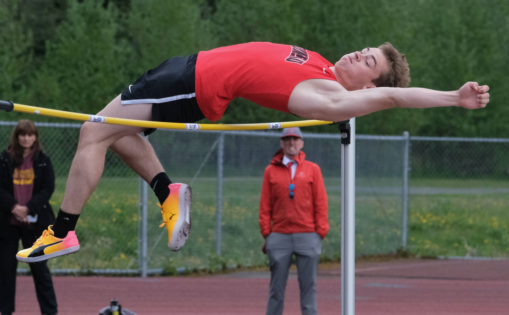 JDHS junior Brendan West wins the DI high jump as coach Jesse Stringer looks on during the Region V Track & Field Championships, Friday, at Thunder Mountain. The championships resume Saturday. (Klas Stolpe / Juneau Empire)