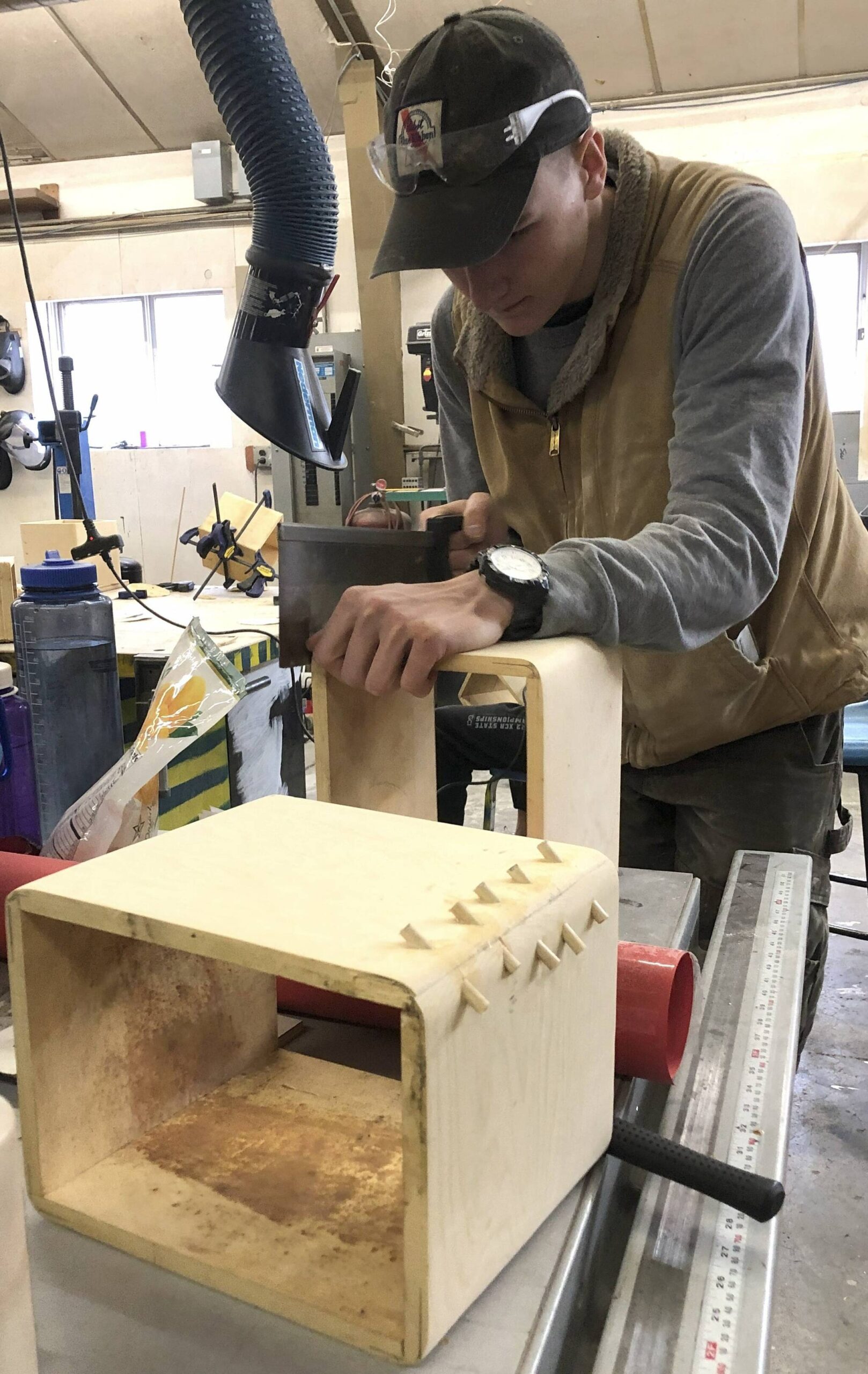 Craig senior Seth McClurgv making the bentwood box and sanding it under the Eagle totem of reused parts that is erected outside the school’s shop in Yakutat for this year’s Alaska Student Activities Association’s Region V Art Fest. (Courtesy Photo / Heather Ridgway)