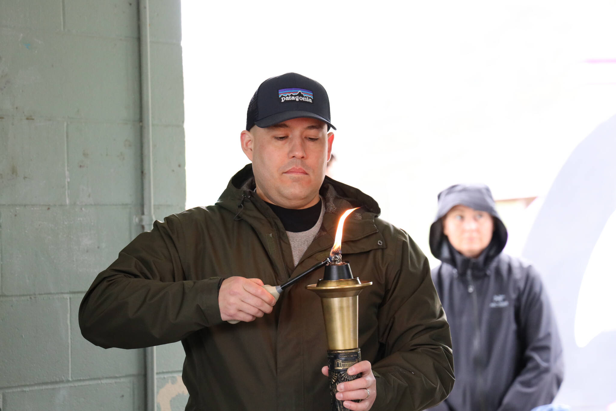 Alaska State Troopers Sgt. Chris Russell lights the torch before the the Alaska Law Enforcement Torch Run began at Twin Lakes Park Saturday morning. (Clarise Larson / Juneau Empire)