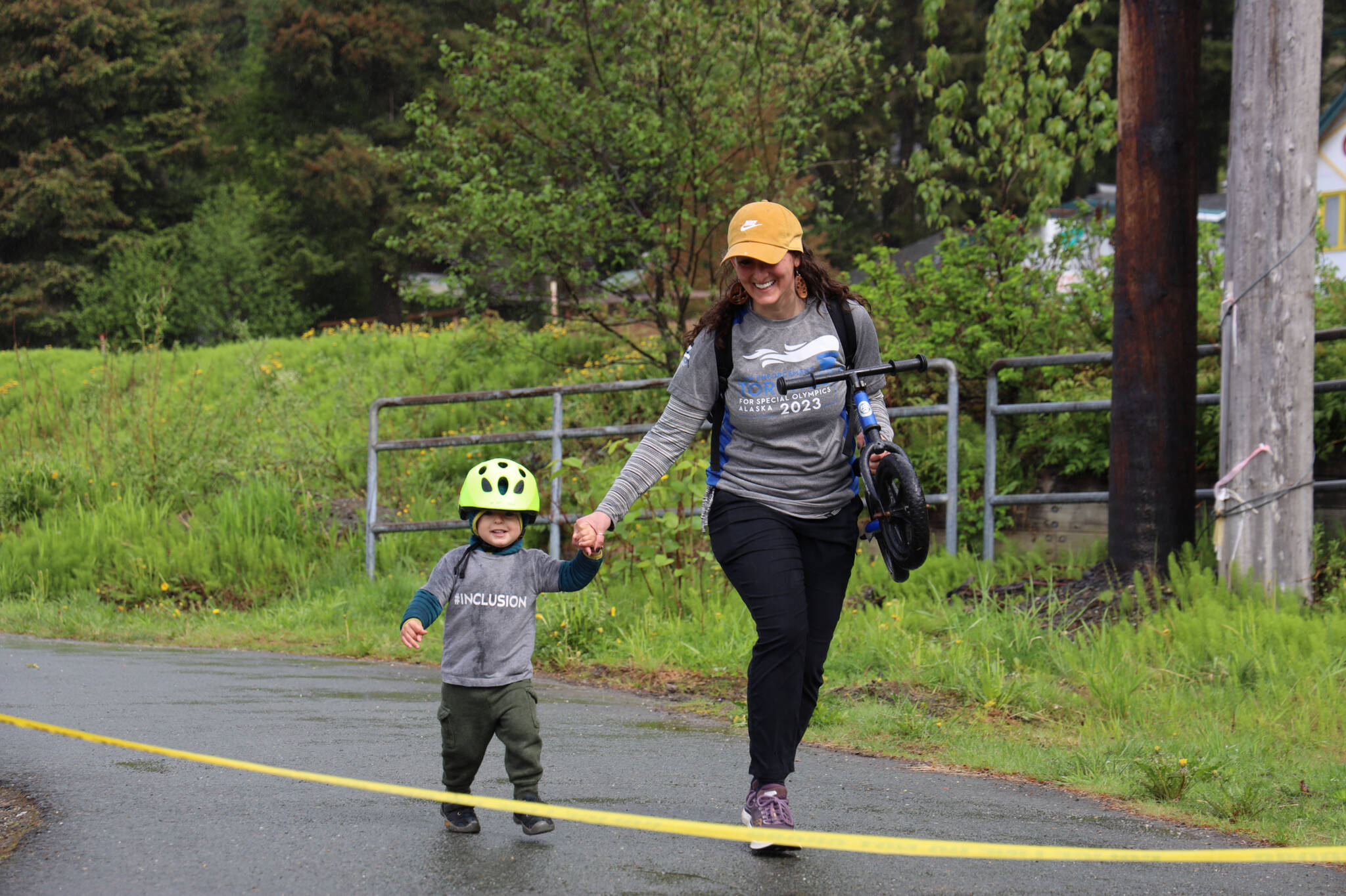 Callan, 2, and his mom Kate Foster run to the finish line during the Alaska Law Enforcement Torch Run at Twin Lakes Park Saturday morning. (Clarise Larson / Juneau Empire)