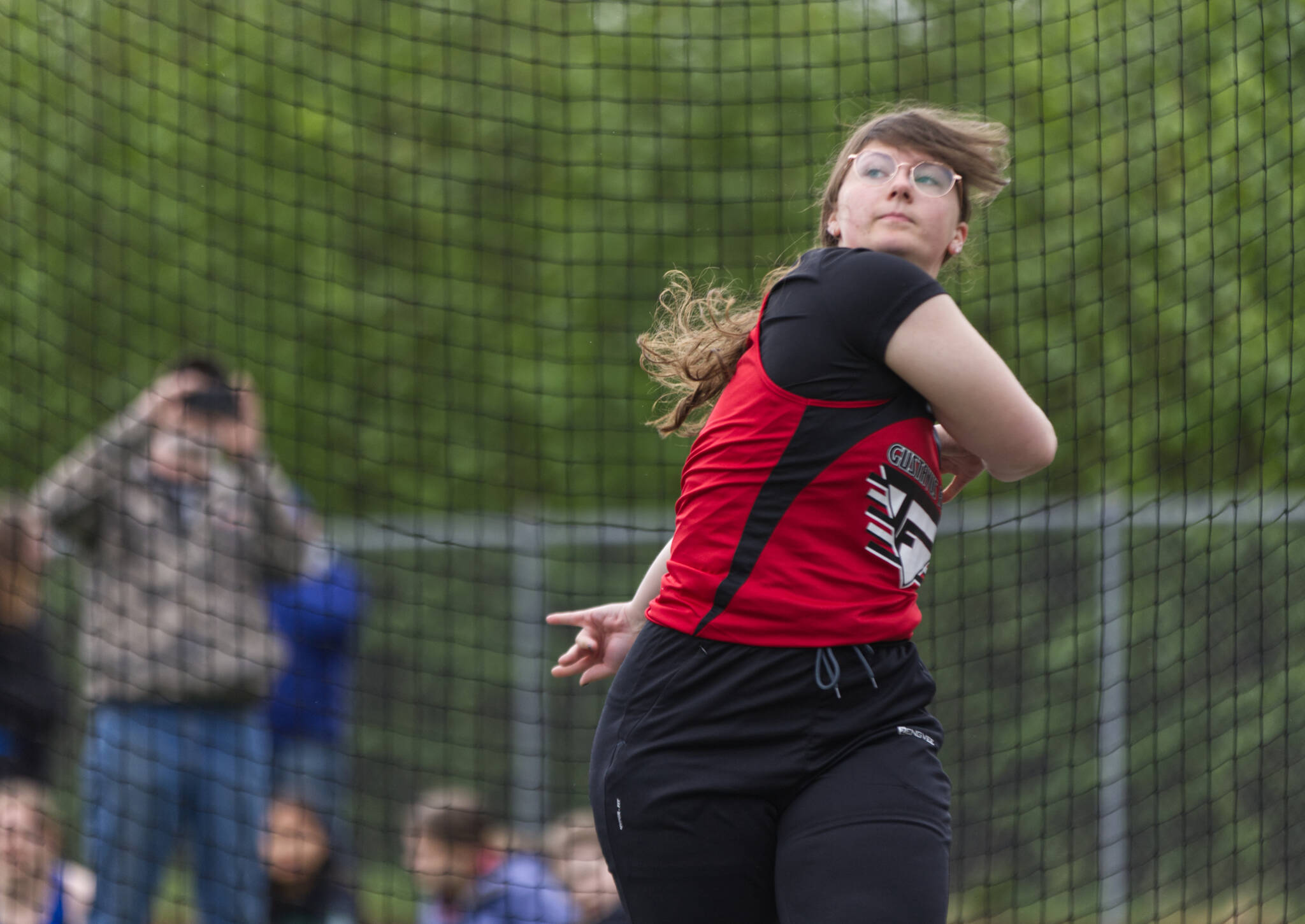 Maddy Wagner, a Gustavus junior, watches the discus fly 81 feet and 6.5 inches Saturday at Thunder Mountain High School. Wagner came in third place for Division II girls in the event during the Region V Track & Field Championships.