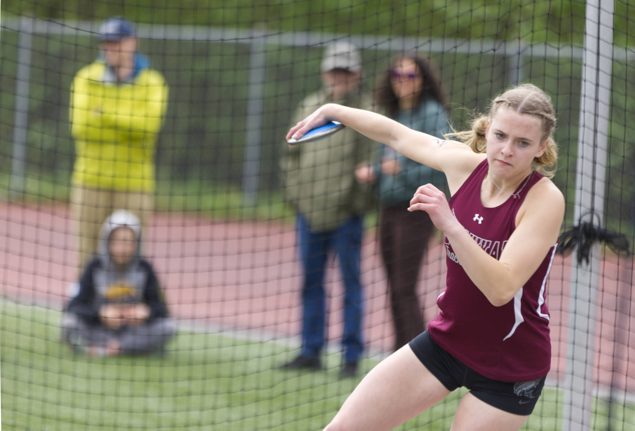 Julia Biagi, a Kayhi junior, gets ready to send a discus on an over 80-foot trip Saturday. Biagi took first place in discus for Division I girls with a distance of 84 feet and 10.5 inches. (Ben Hohenstatt / Juneau Empire)