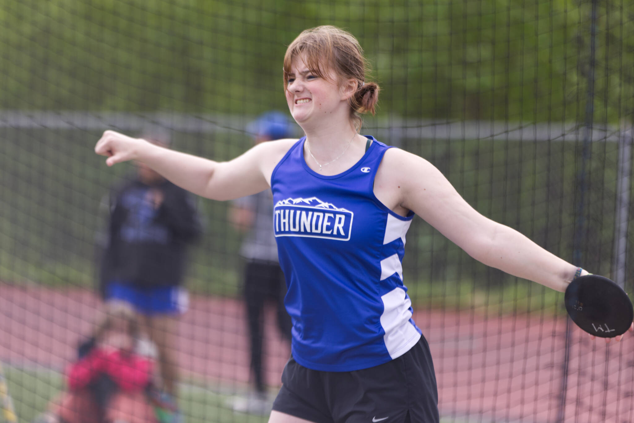 Amelia Lockwood, a Thunder Mountain sophomore, grits her teeth before sending a discus sailing. Lockwood placed second in Division I girls discus with a distance of 61 feet and 3 inches at the Region V Track & Field Championships held Friday and Saturday at TMHS. (Ben Hohenstatt / Juneau Empire)