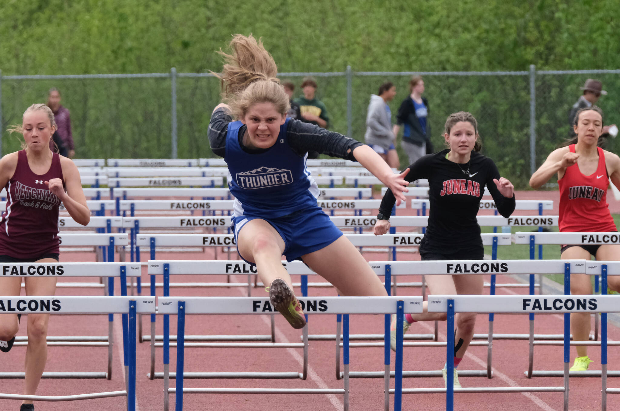 Thunder Mountain High School senior Mallory Welling leads the field en route to winning the girls 100 meter hurdles during the Region V Track & Field Championships, Saturday, at TMHS. From left: Ketchikan junior Linnea Loretan, Welling, Juneau-Douglas junior Hannah Brennell and JDHS freshman Isabella Reyes-Boyer. (Klas Stolpe / Juneau Empire)