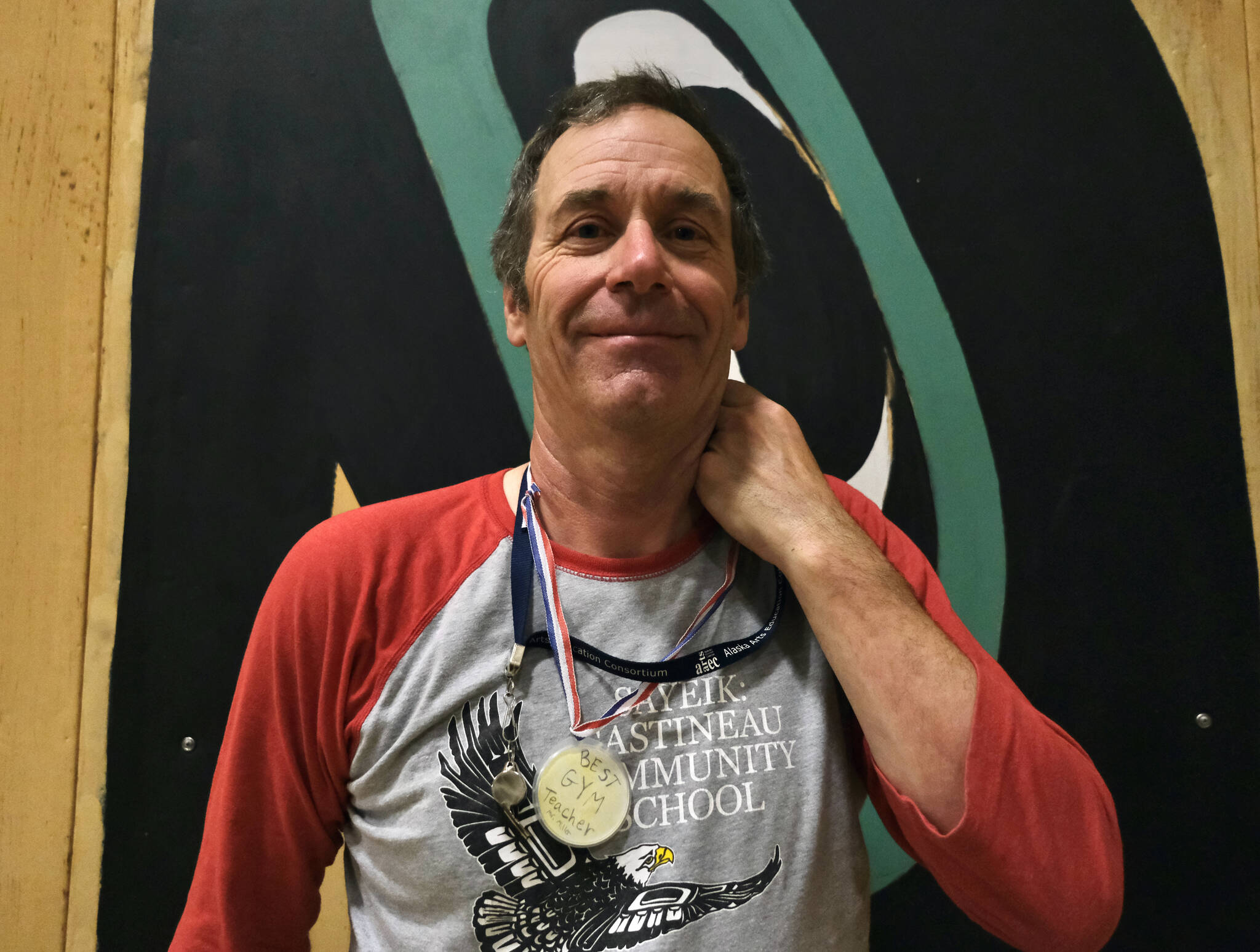 Sayéik: Gastineau Community School physical education teacher Dirk Miller displays one of his favorite awards on Thursday, a medal made by a student. Miller is retiring after 24 years at the school. (Klas Stolpe / Juneau Empire)
