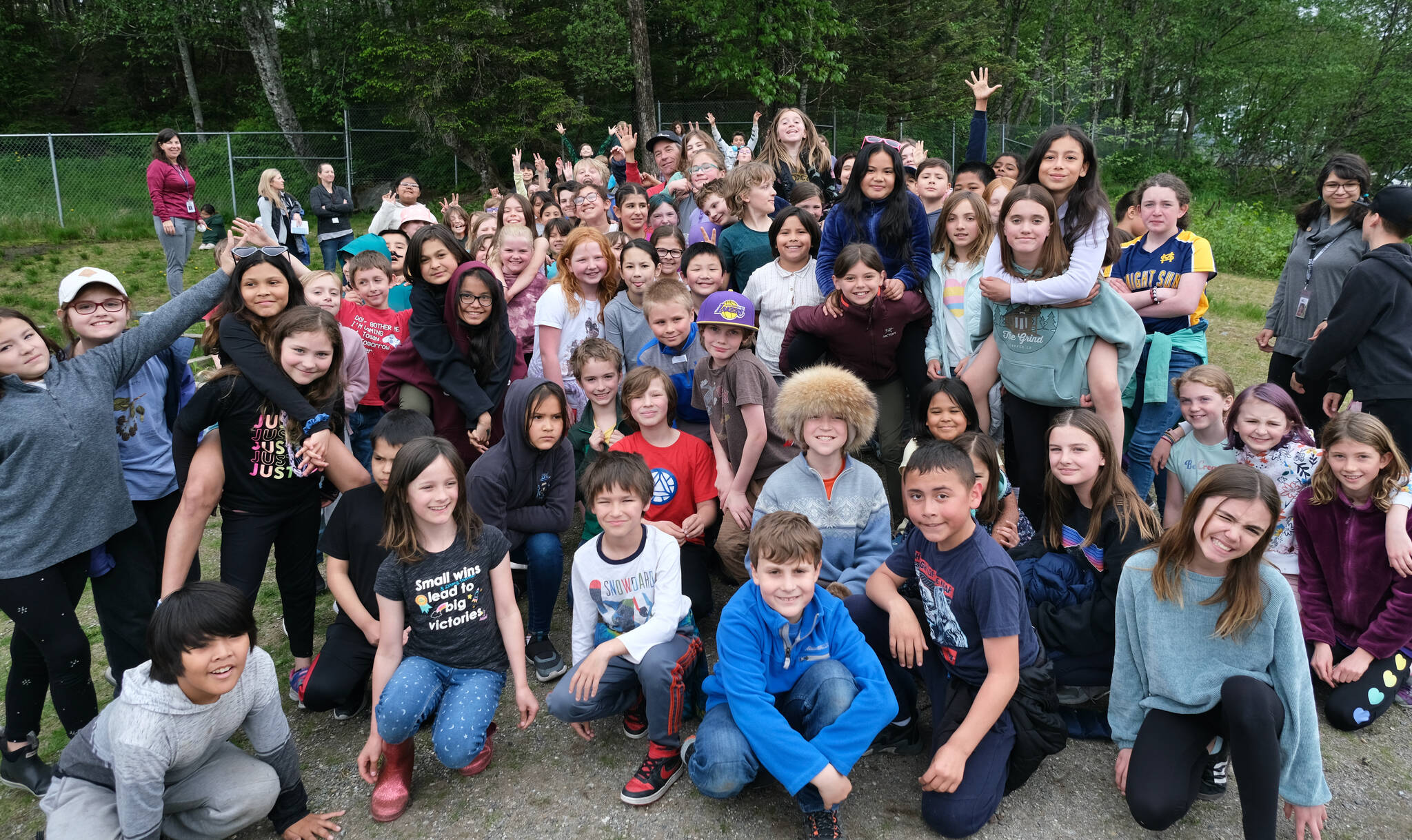 Sayéik: Gastineau Community School students pose with physical education teacher Dirk Miller, top middle, during Field Day at the school on Thursday. Miller is retiring after 24 years at the school. (Klas Stolpe / Juneau Empire)