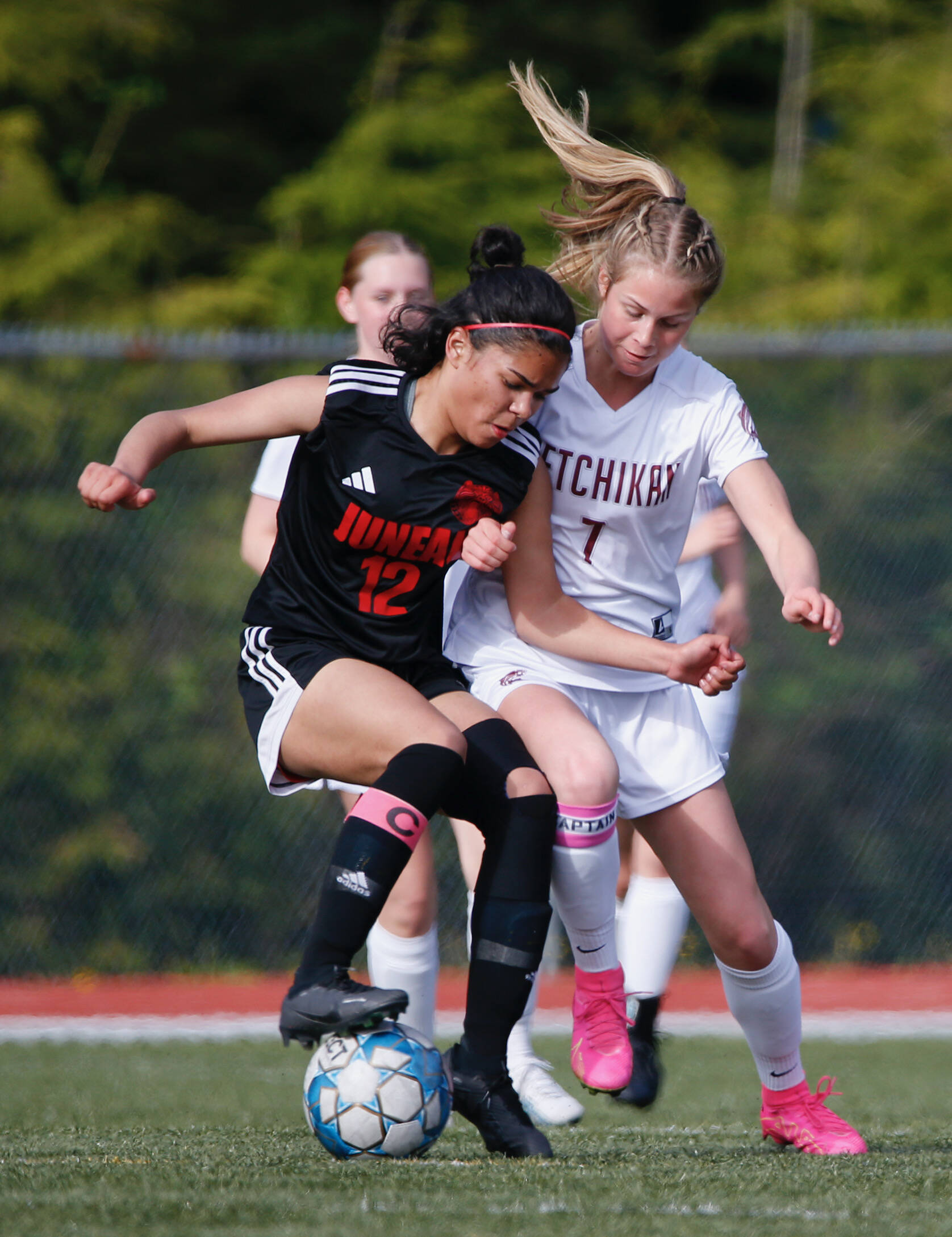 In this May 19 photo, Juneau Douglas’s Cadence Plummer (12) and Kayhi’s Aspen Bauer (7) battle for the ball during Juneau-Douglas and Kayhi’s 1-1 tie at Fawn Mountain. Photo by Christopher Mullen Ketchikan Daily News