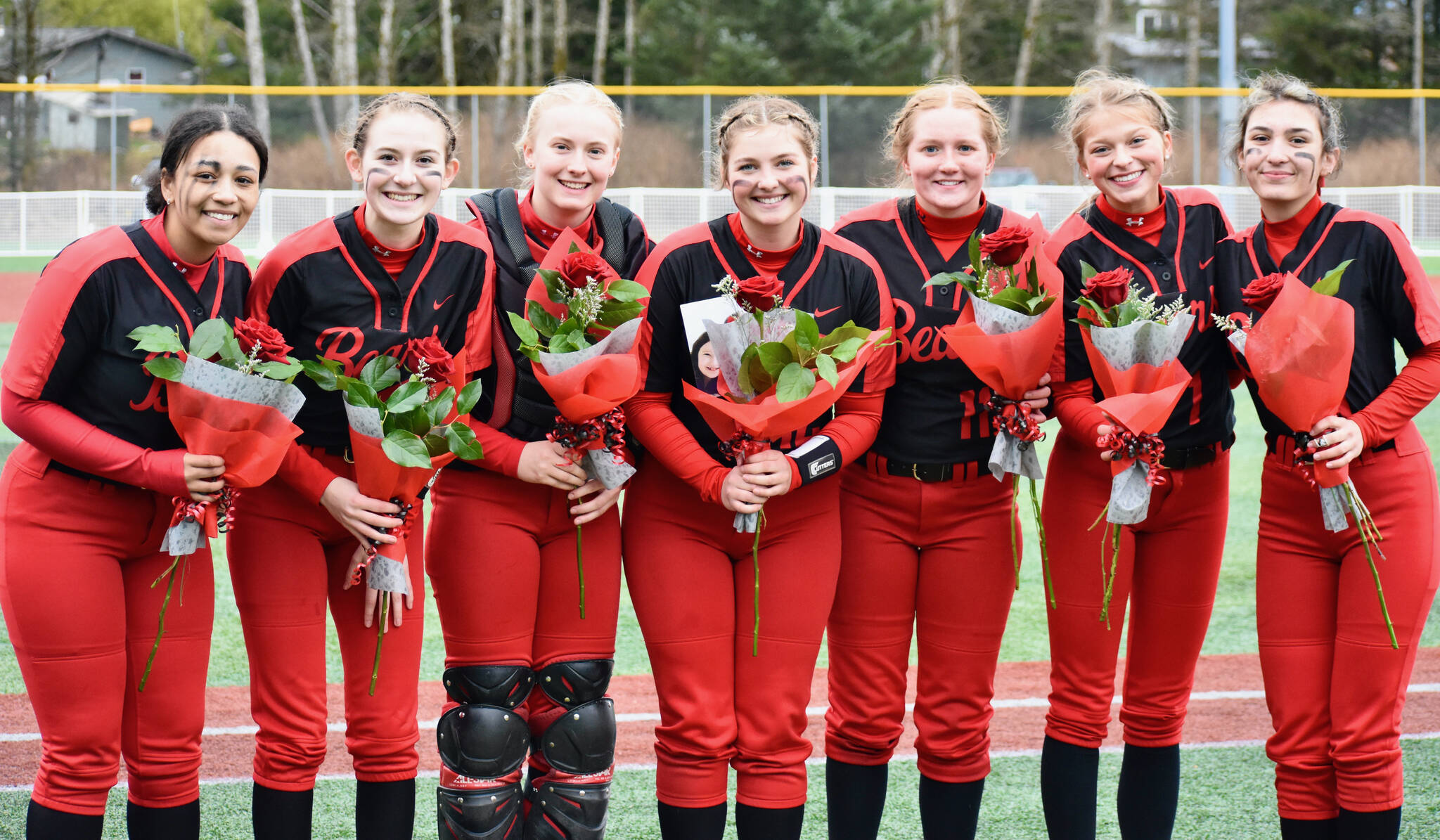 This photo shows Juneau-Douglas High School: Yadaa.at Kalé Crimson Bears senior softball players Amira Andrews, Carlynn Casperson, Anna Dale, Gloria Bixby, Mariah Schauwecker, Zoey Billings and Bailey Hansen. JDHS plays in a semifinal against Sitka at 6 p.m. Friday in the Region V Tournament on Sitka’s Moller Field. (Courtesy Photo / JDHS Softball)