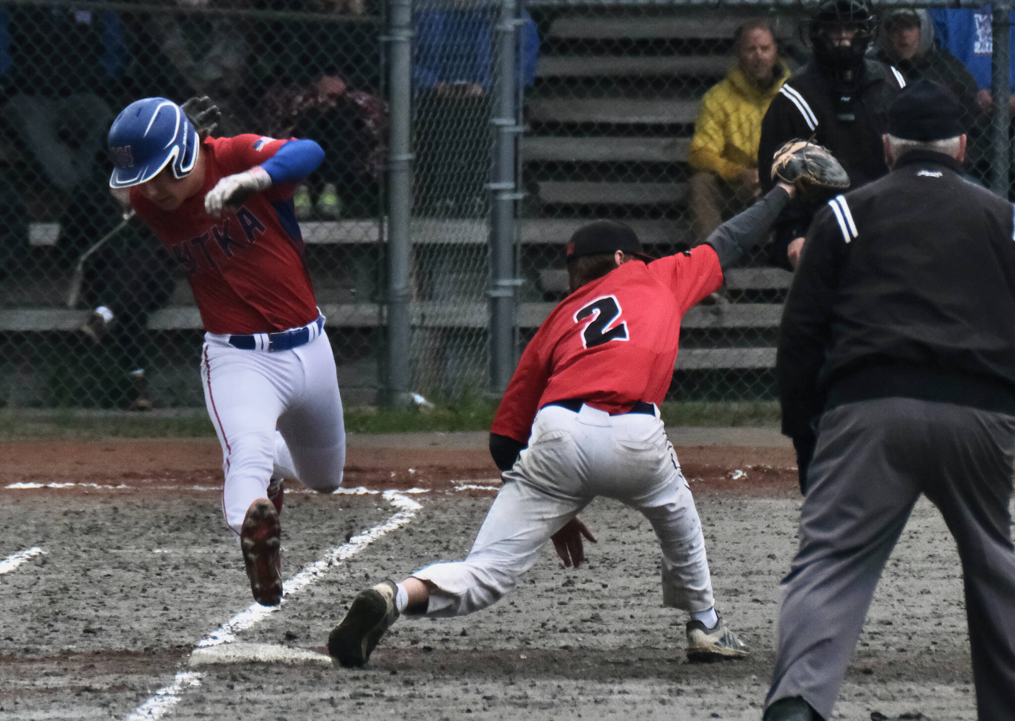 Sitka senior Dylan Marx is put out at first base by Juneau-Douglas High School: Yadaa.at Kalé senior Bodhi Nelson during the Wolves 9-2 win over the Crimson Bears during the Region V Baseball Tournament, Friday, at Adair Kennedy Field. (Klas Stolpe / Juneau Empire)