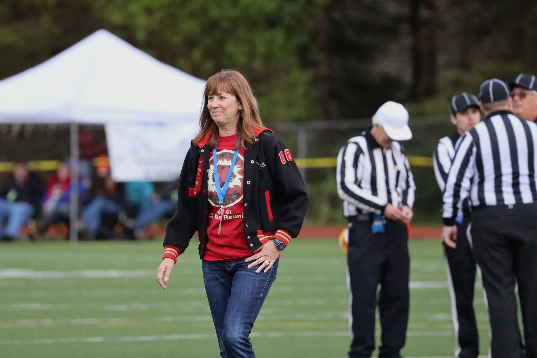 Outgoing Juneau School District Superintendent Bridget Weiss walks off the field after participating as the game’s honorary coin tosser. (Clarise Larson / Juneau Empire)