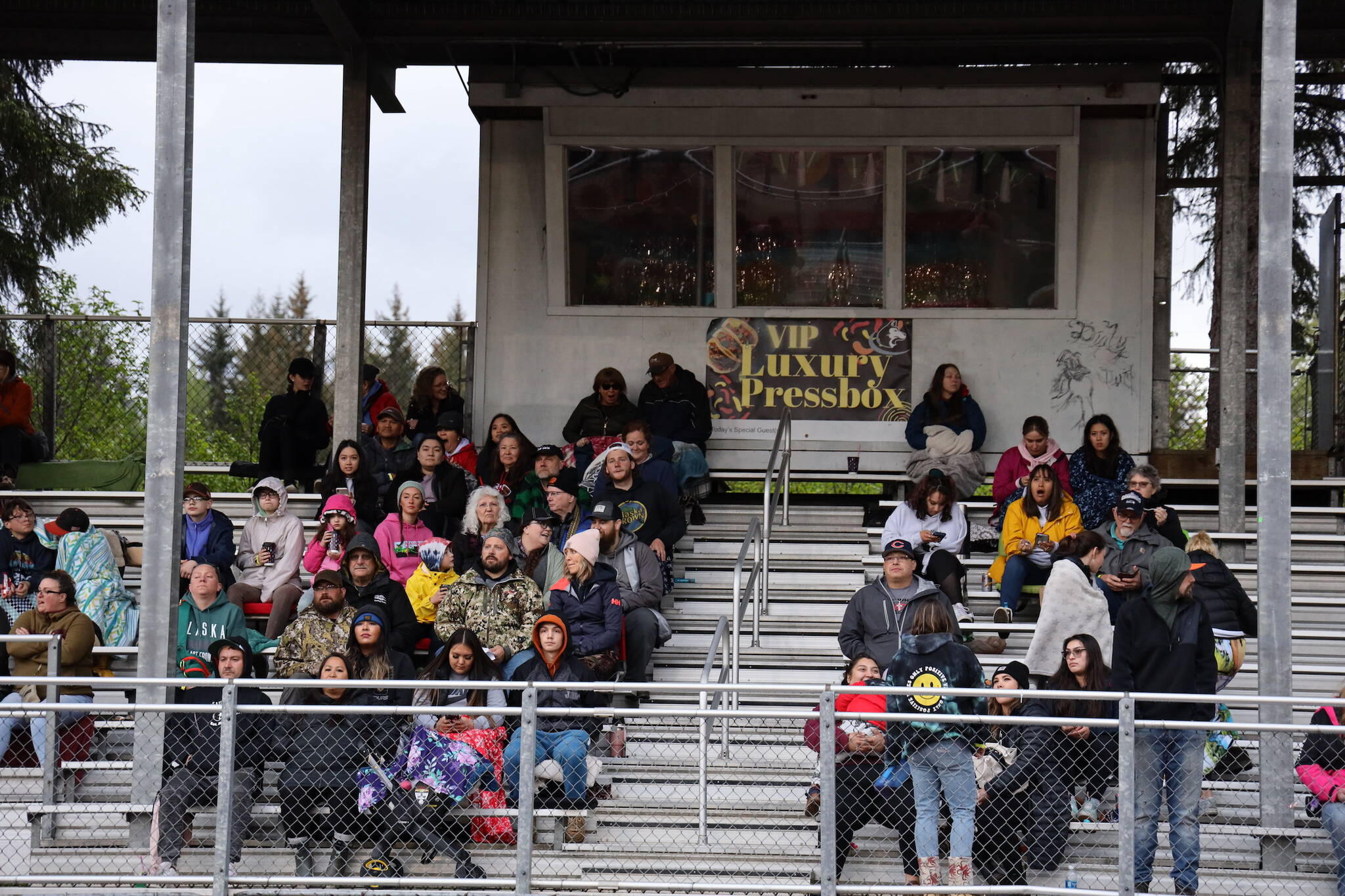 Fans and family members fill the bleachers at Adair-Kennedy Field on Friday during the Juneau Alumni Football game. (Clarise Larson / Juneau Empire)