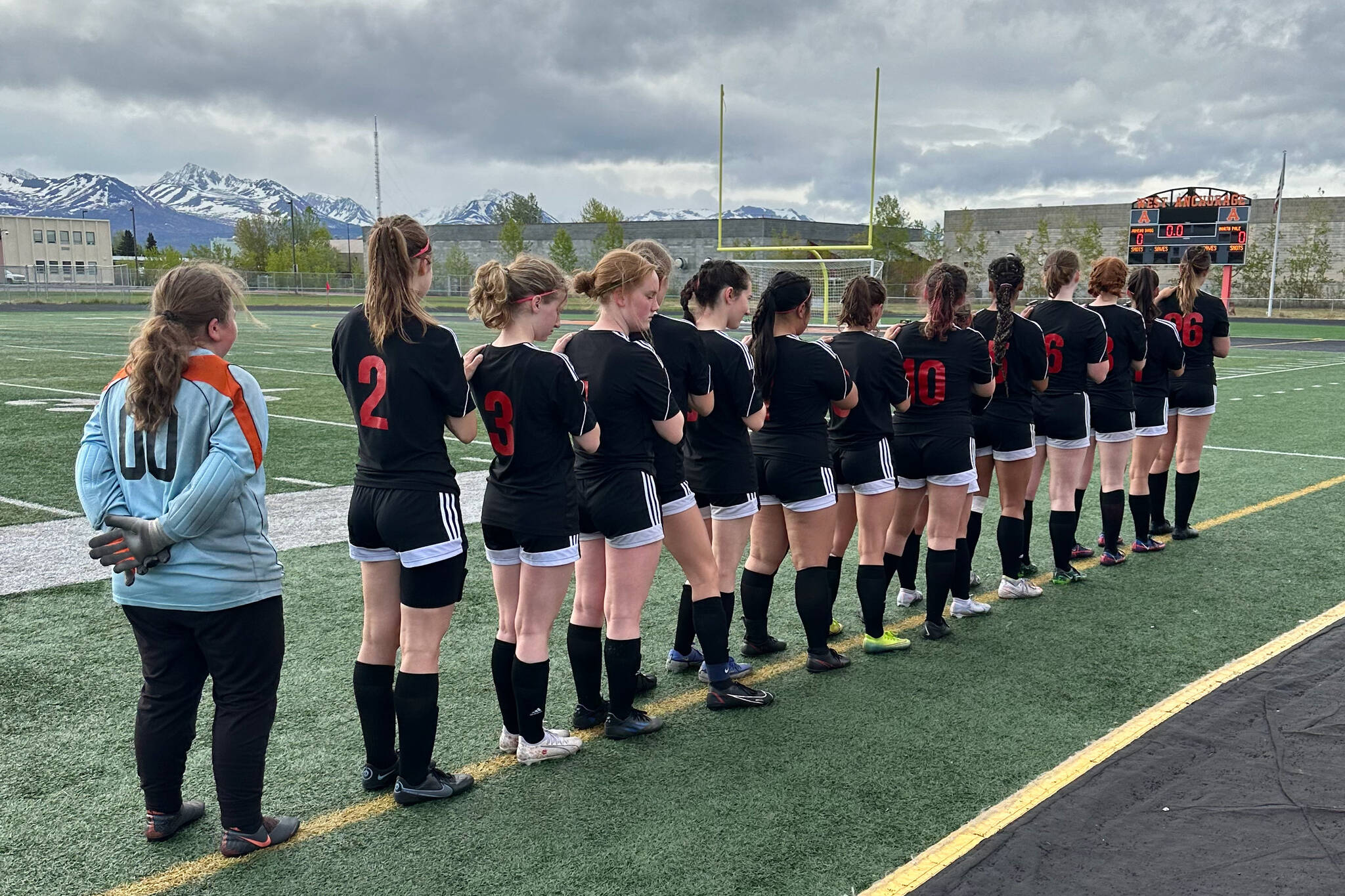 The Juneau-Douglas High School: Yadaa.at Kalé Crimson Bears girls soccer team line up before their third/fifth place game against North Pole in the ASAA DII Girls Soccer State Championships, Saturday, at West Anchorage High School. (Courtesy Photo / JDHS Soccer)