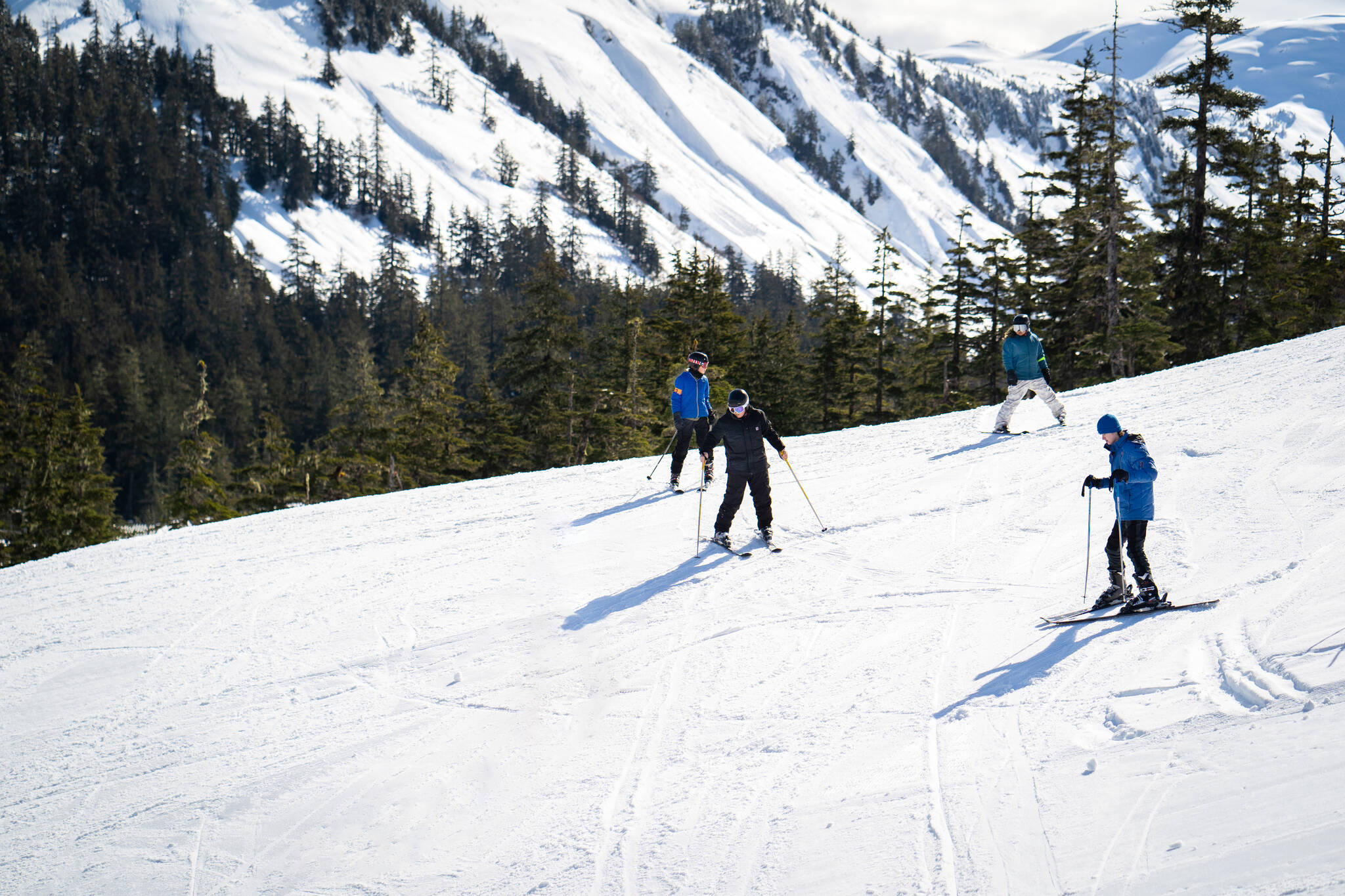 From left to right, Ryland Carlson, Judah Haven Marr, Makia Mills, and Dylan DeAsis, four Douglas Indian Association Snow Camp participants, gather at the top of a run before dropping in.