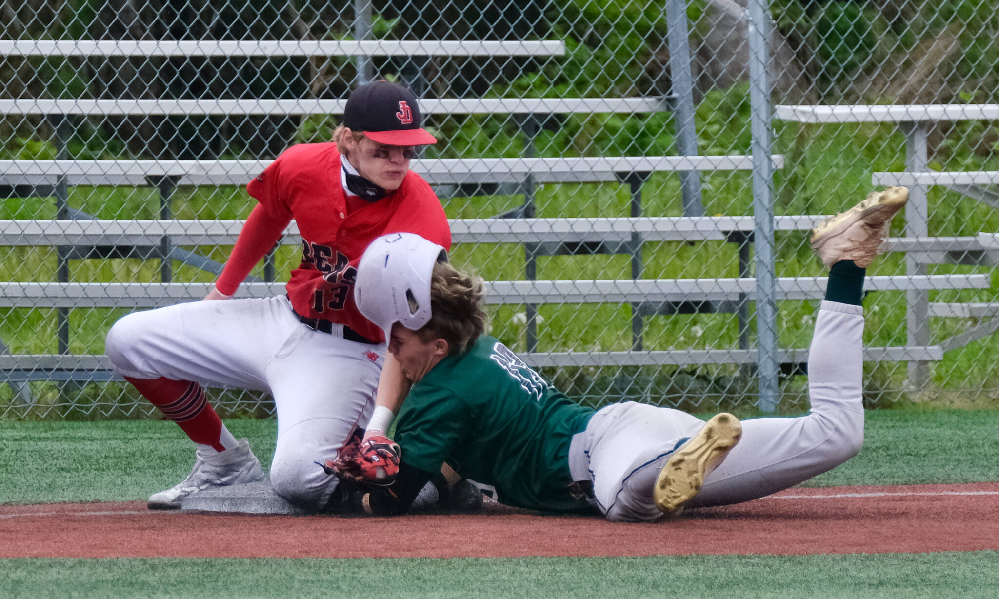 JDHS senior third baseman Kaleb Campbell tags out Colony freshman Kaesen Buzby on a steal attempt during the Crimson Bears 9-1 loss to the Knights on Thursday in the opening round of the ASAA Division I State Baseball Championships at Sitka’s Moller Field. (Klas Stolpe / Juneau Empire)