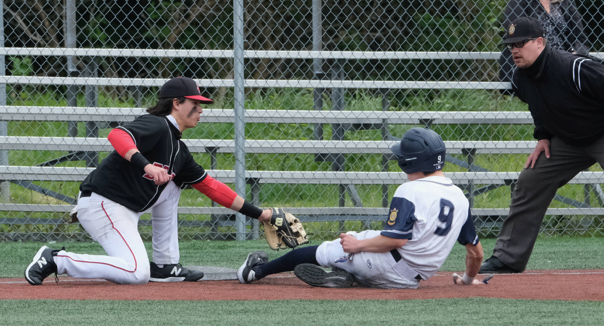 JDHS junior third baseman Landon Simonson tags out an Eagle River base runner during the Crimson Bears 2-1 loss to the Wolves in an elimination game Friday at the ASAA Division I State Baseball Championships on Sitka’s Moller Field. (Klas Stolpe / Juneau Empire)