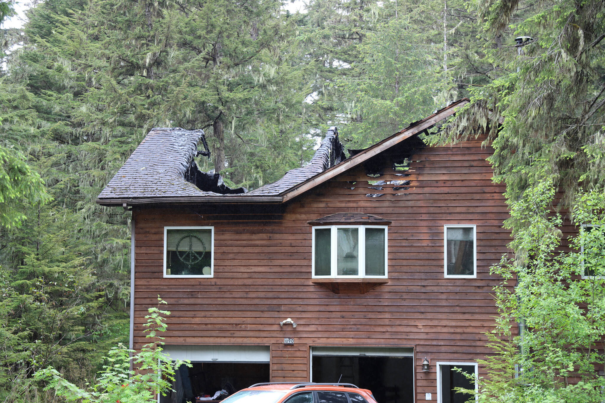 Portions of the roof of a home in the Fritz Cove area near Fox Farm Trail are caved in following a structure fire Tuesday morning. No injuries were reported. (Clarise Larson / Juneau Empire)