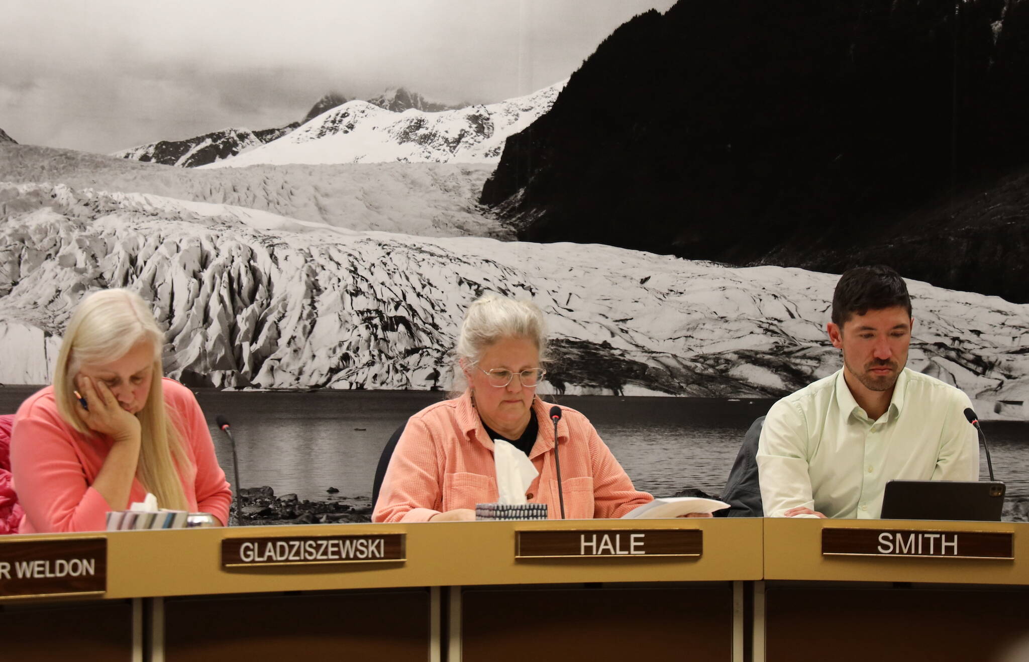 Assembly members Maria Gladziszewski, Michelle Bonnet Hale and Greg Smith listen as the City and Borough of Juneau budget for the 2024 fiscal year is finalized and approved after a more than three-hour-long meeting Monday night. (Clarise Larson / Juneau Empire)
