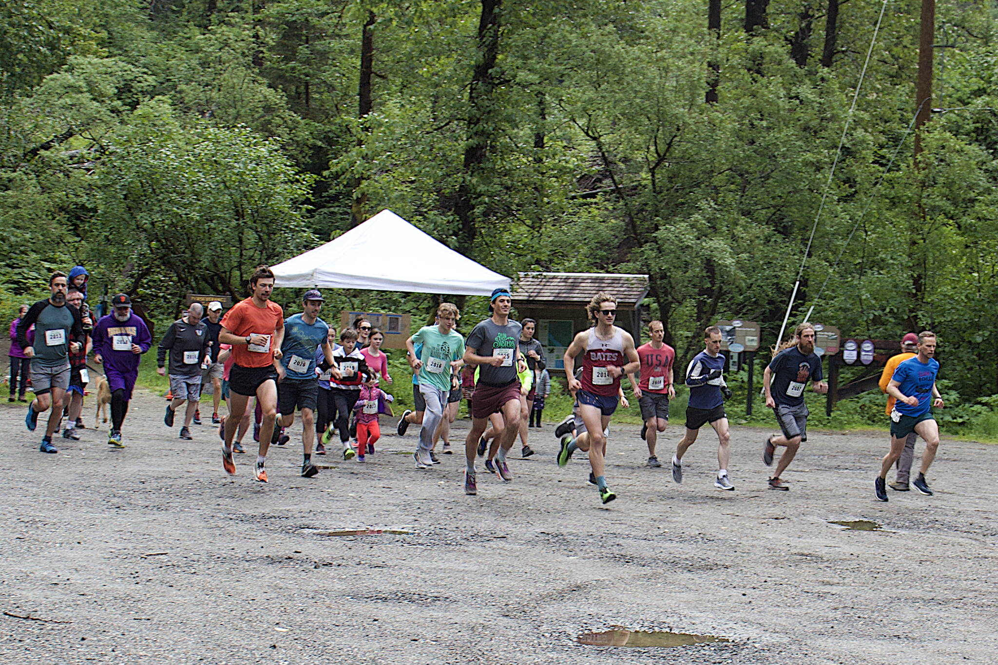 About 30 people take off from the starting line at the Ben Blackgoat Memorial Run on Saturday morning at the base of Perseverance Trail. The race, named after a Juneau teenage who died in an accident on the trail, was the first by the Juneau Trail and Road Runners since it officially added a nonbinary category for participants. (Mark Sabbatini / Juneau Empire)