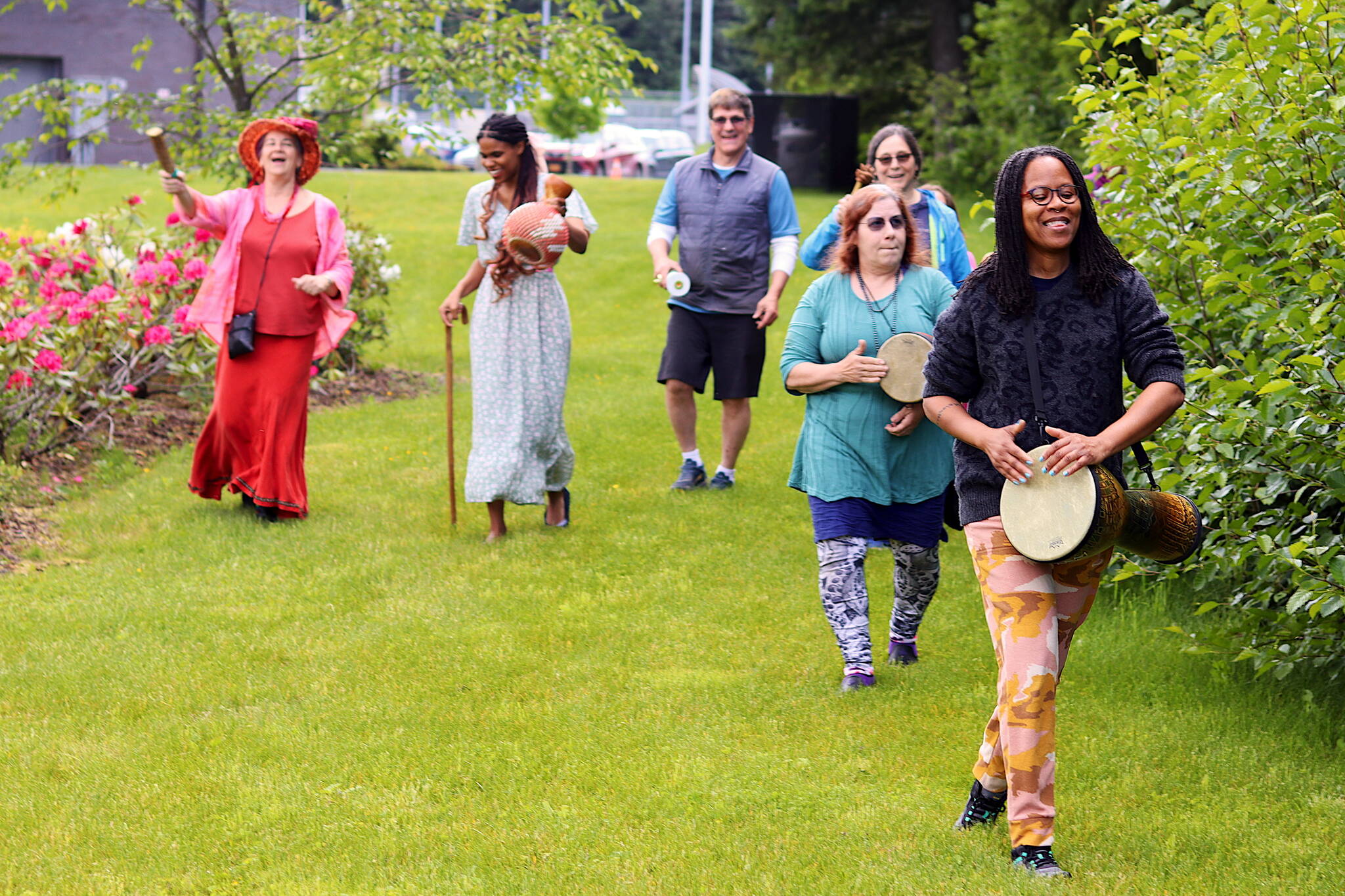 Hannahadina Kuhnert leads a music procession outside the Mendenhall Valley Public Library on Saturday during a Juneteenth celebration where participants heard the history of the June 19 holiday and made their own musical instruments. (Mark Sabbatini / Juneau Empire)