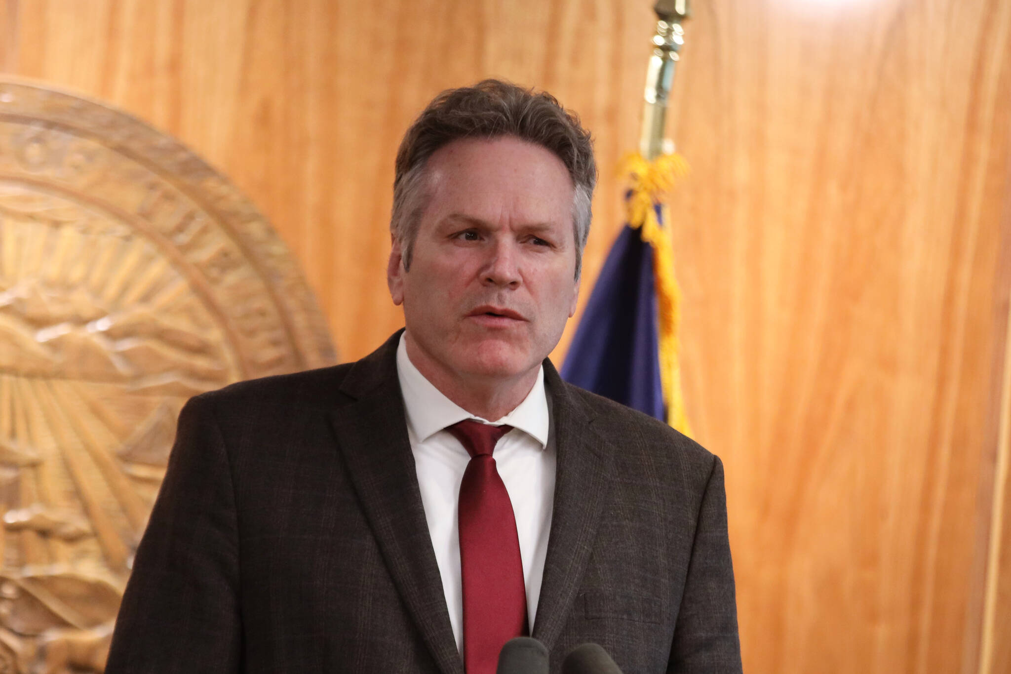 Gov. Mike Dunleavy speaks during a news conference in April focusing on the budget and a long-range fiscal plan for the state. He signed the budget for the fiscal year starting July 1 on Sunday, but did not publicly announce the signing or line-item vetoes made — including cutting in half an increase to public education spending — until Monday. (Clarise Larson / Juneau Empire File)