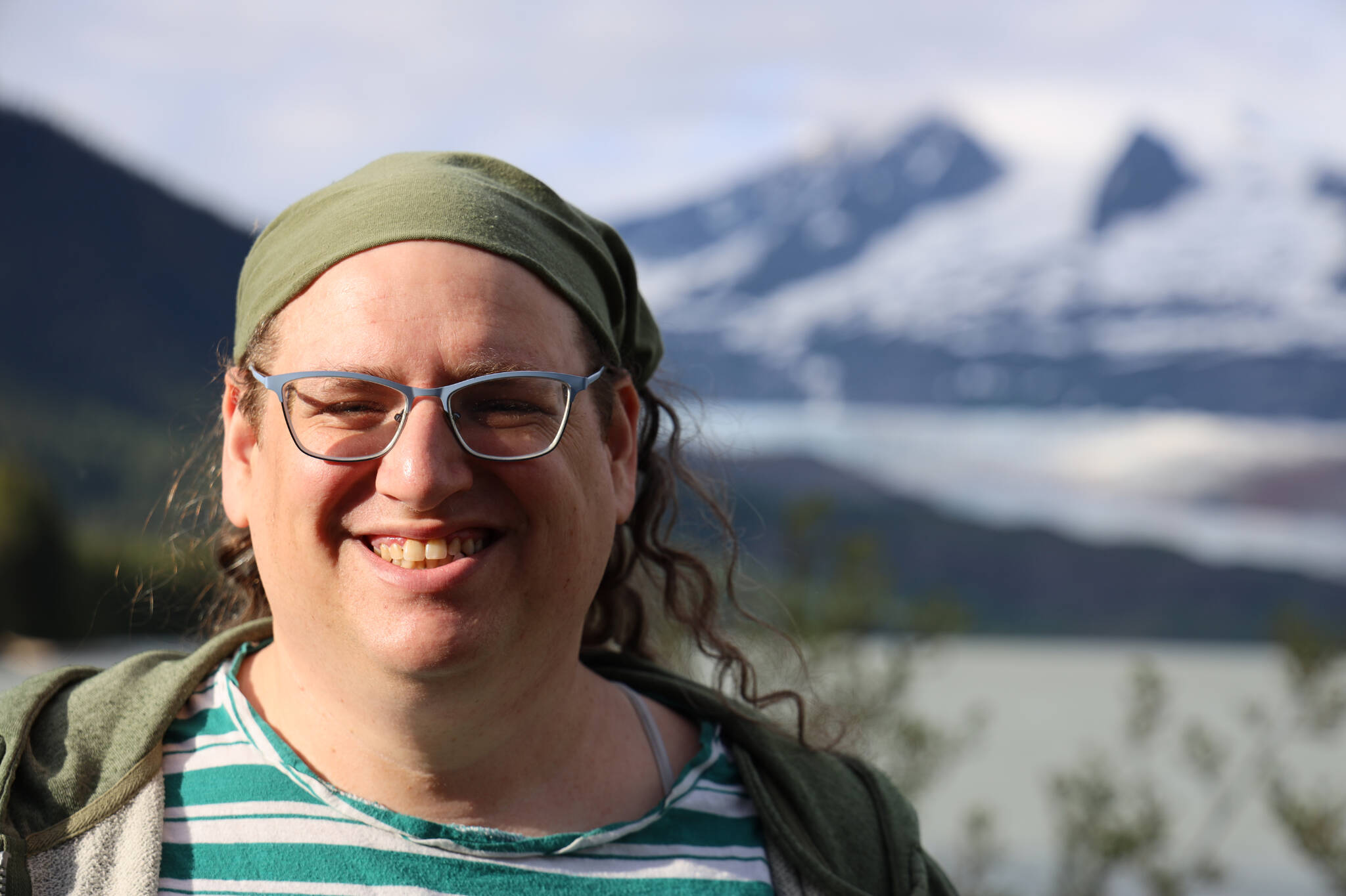 Emily Mesch, president of Southeast Alaska LGBTQ+ Alliance, smiles for a photo near the Mendenhall Glacier Thursday evening. SEAGLA is a Juneau-based nonprofit that works to “provide a supporting social network for gay, lesbian, bisexual, transgender, and queer people in Southeast Alaska.” (Clarise Larson / Juneau Empire)