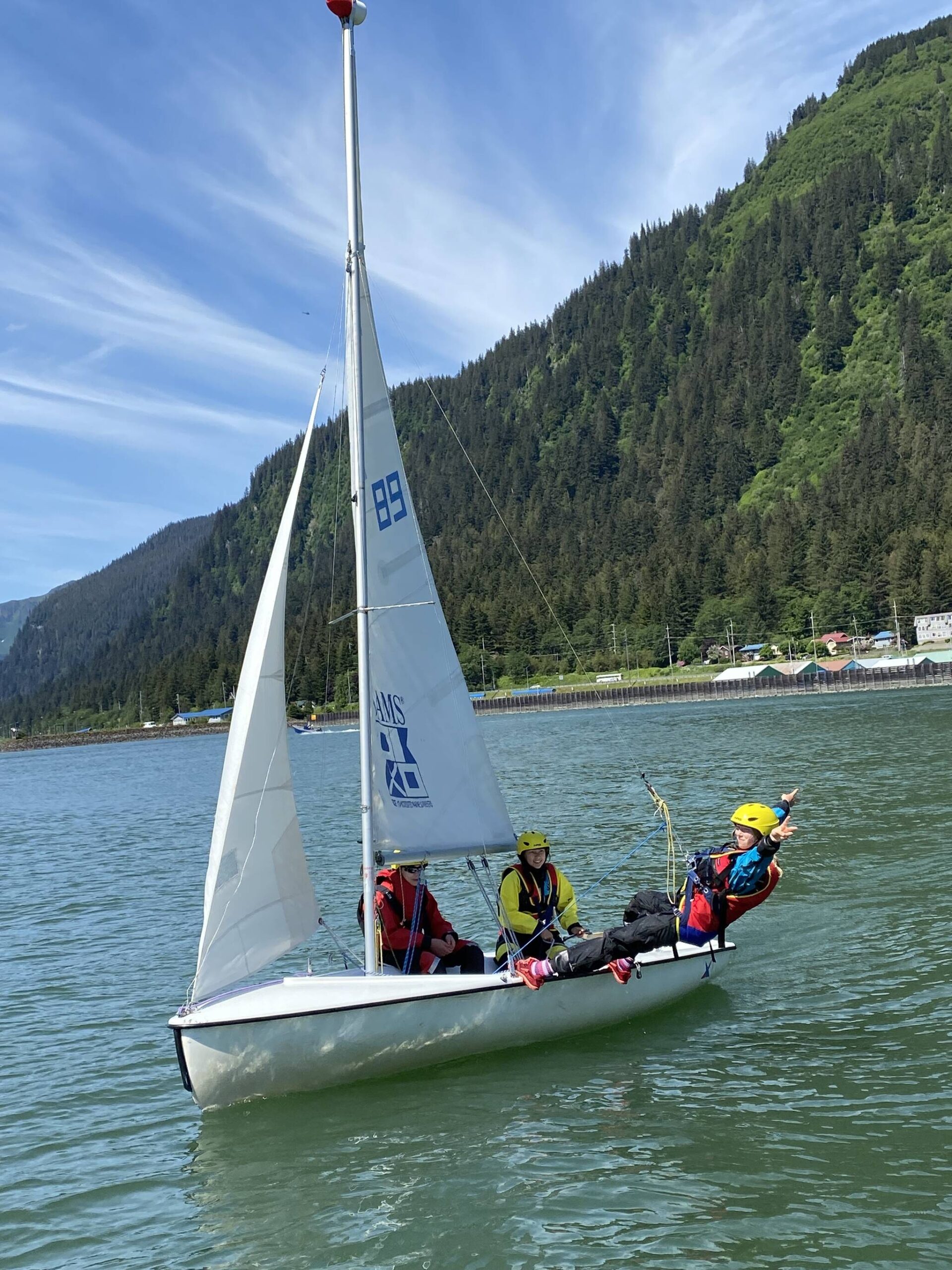 Jack Adams, 15, Lua Mangaccat, 15, and Sigrid Eller, 13, enjoy calm waters in Gastineau Channel during a Juneau Youth Sailing course this week. (Photo by Adrian Whitney)